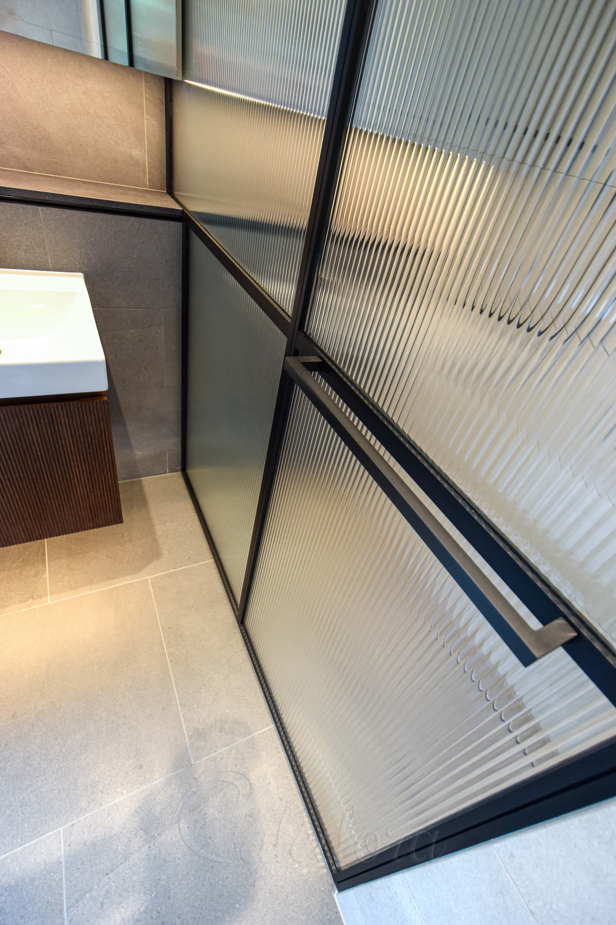 Black anodised shower frame and towel rail showing superior finish durability