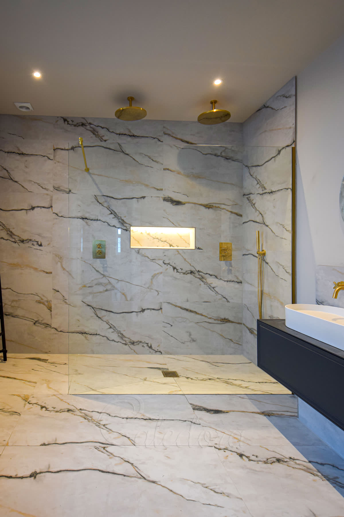 Large brushed brass shower screen — full-height brushed brass framed panel in a bathroom