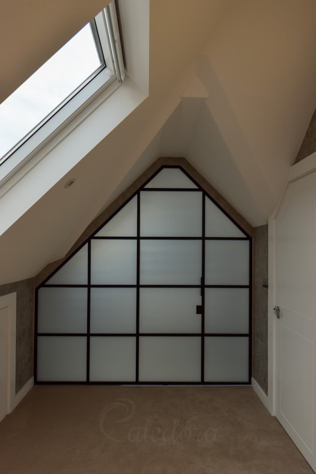 Reeded glass laminated over a milky interlayer in a black grid screen cut to the eaves on both sides, separating a bedroom from a wet room