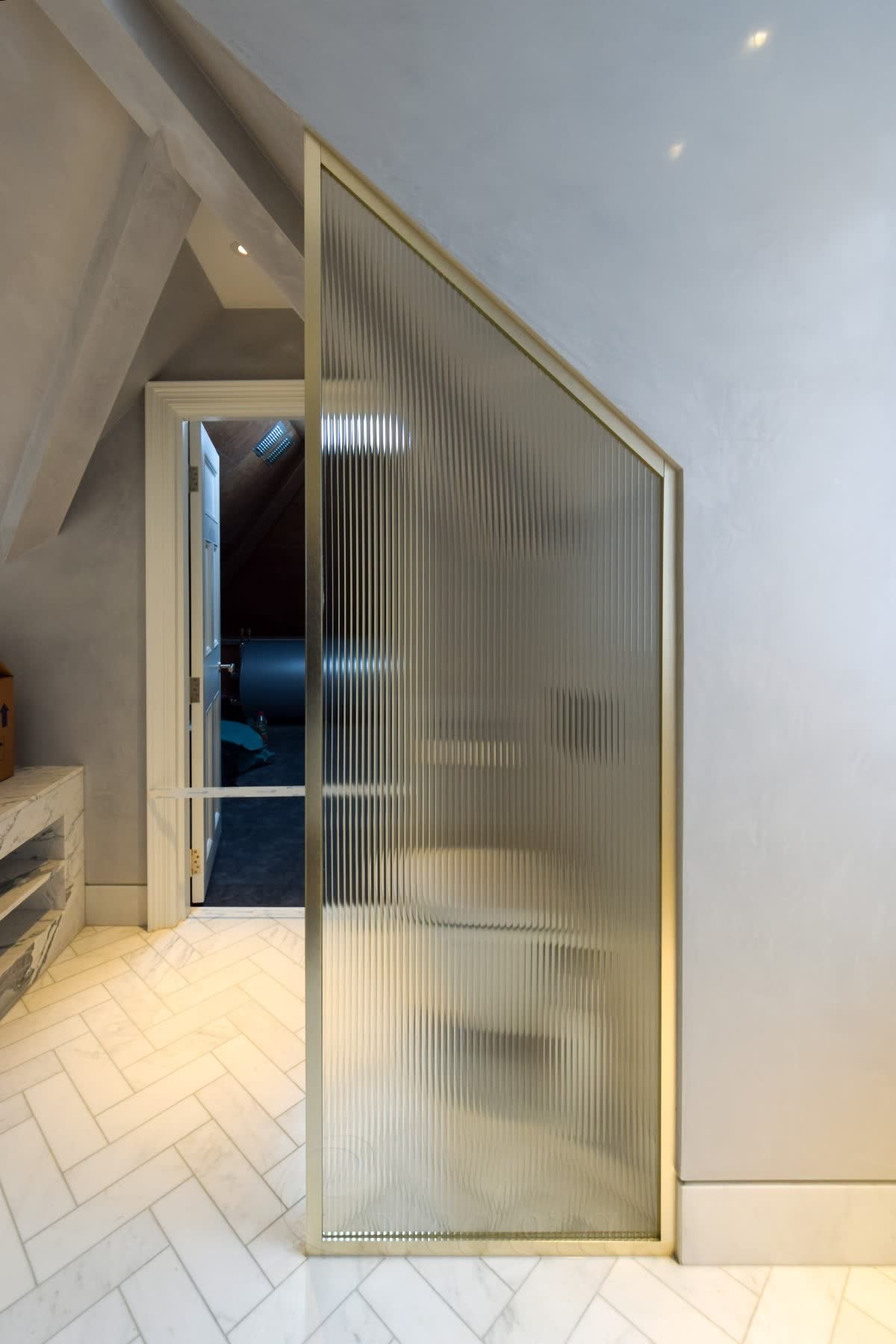 Reeded glass walk-in shower screen in a bronze frame