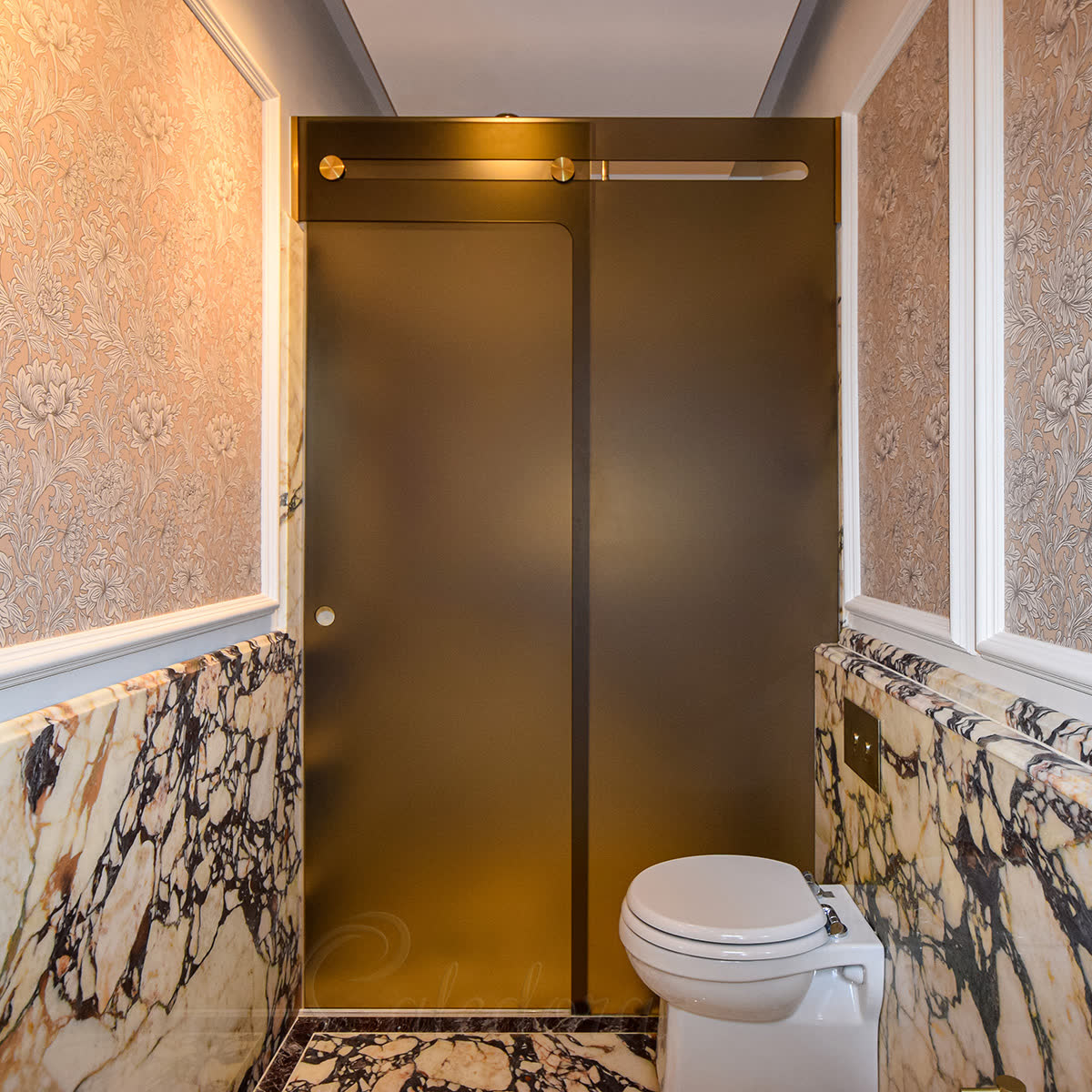 Custom bronze-tinted shower glass with sandblasted face in unique L-shape frameless enclosure with trackless brass slider