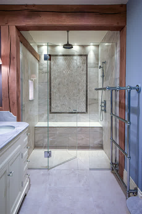 inline shower door and two panels separating bathroom from the bath behind