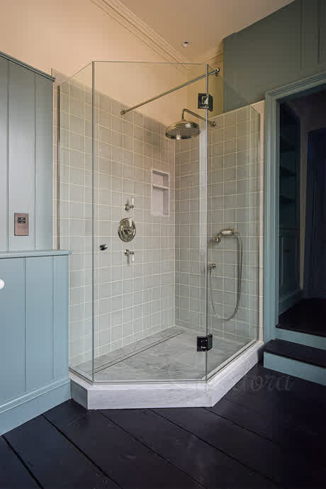 pentagon type shower enclosure on a custom made white tray
