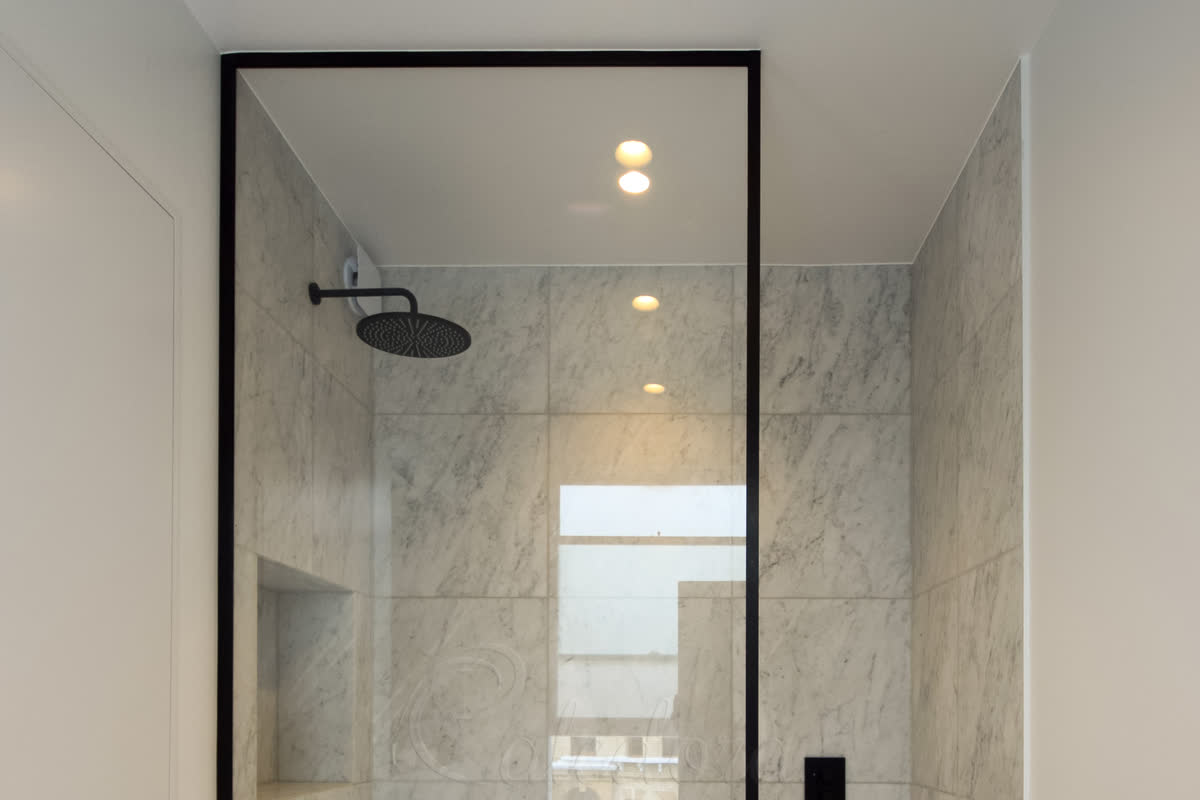 Black-frame glass shower screen with full-height single panel in a London bathroom