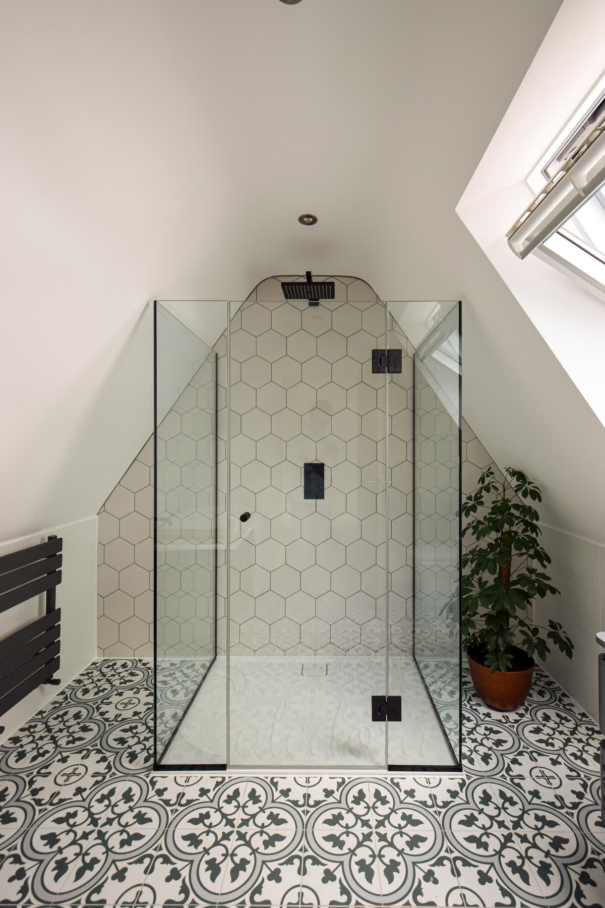 Closed frameless 3-sided shower enclosure with UV-bonded glass corner and clean lines