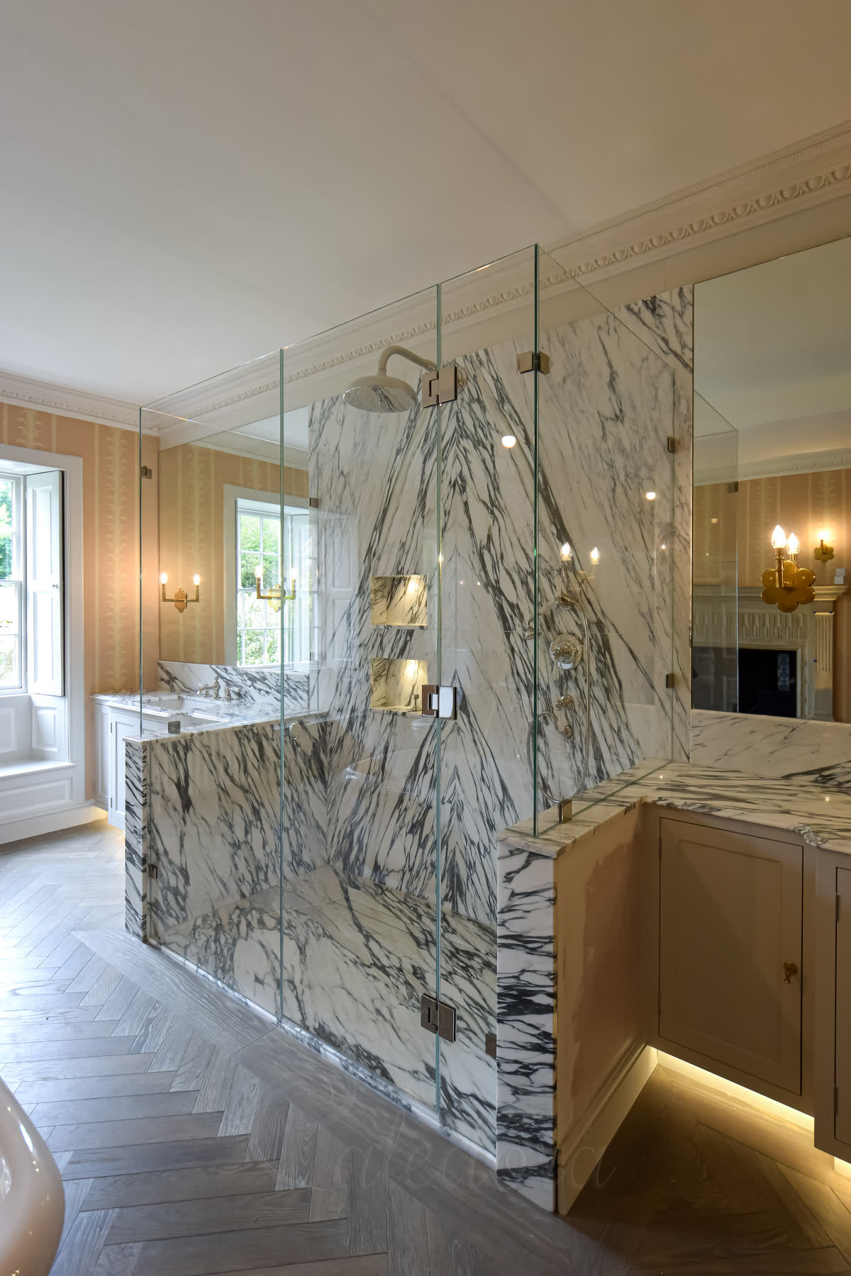 Three-sided frameless shower enclosure door opened inward over stone tray