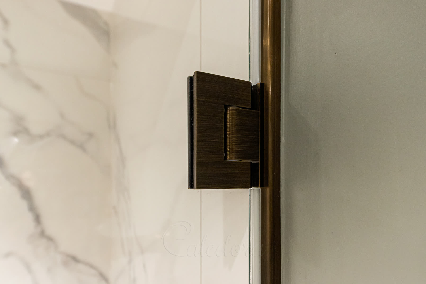 Antique brass shower door hinge showing quality brass finish and wall mounting