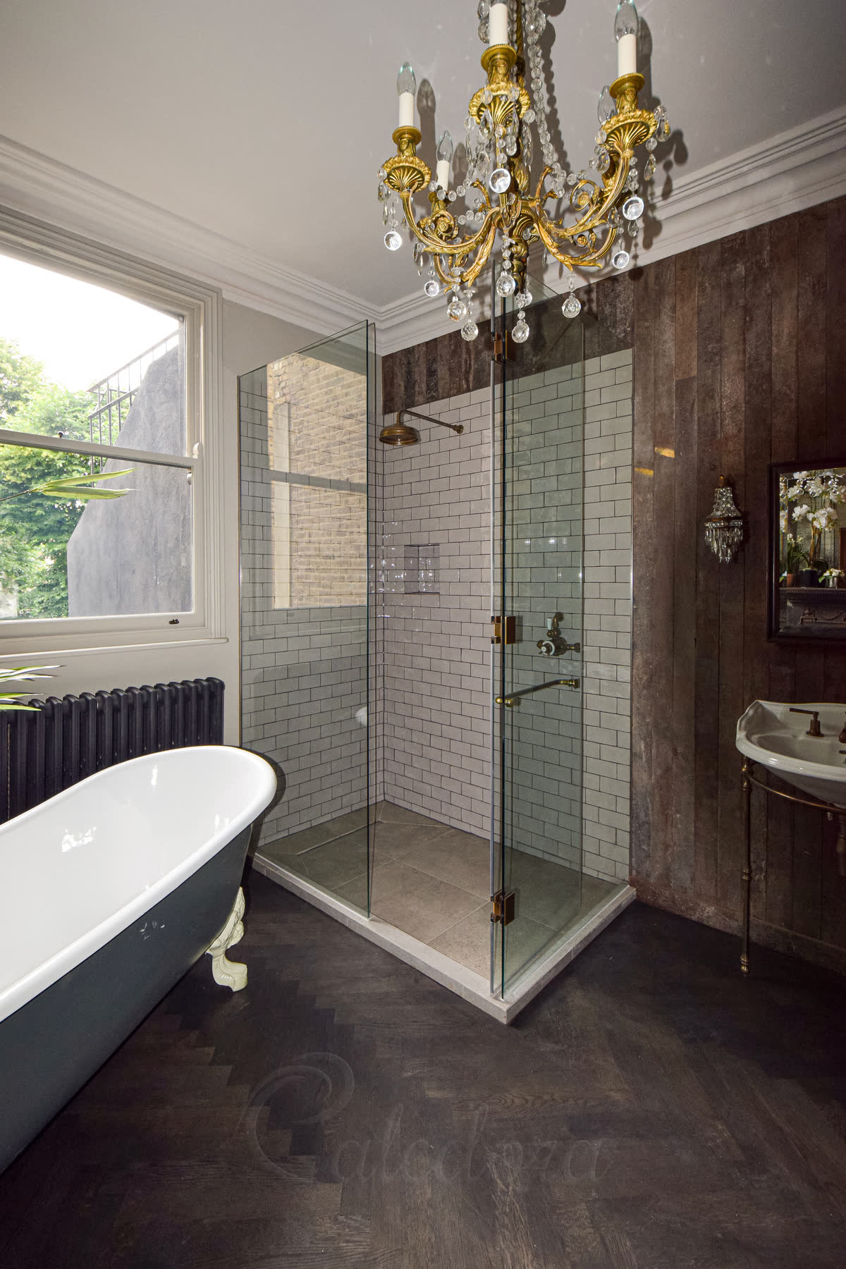 Antique brass shower door open inward showing towel rail mounted on door for convenient towel placement