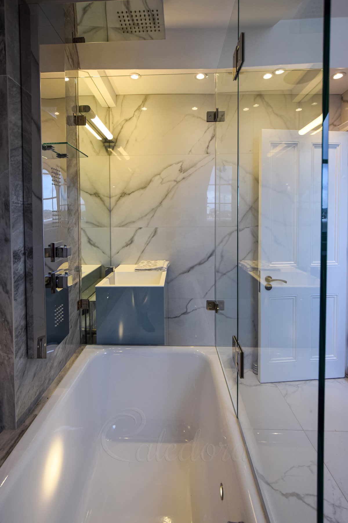 Bath shower enclosure with 90-degree corner design and hinged shower door over bath in modern bathroom