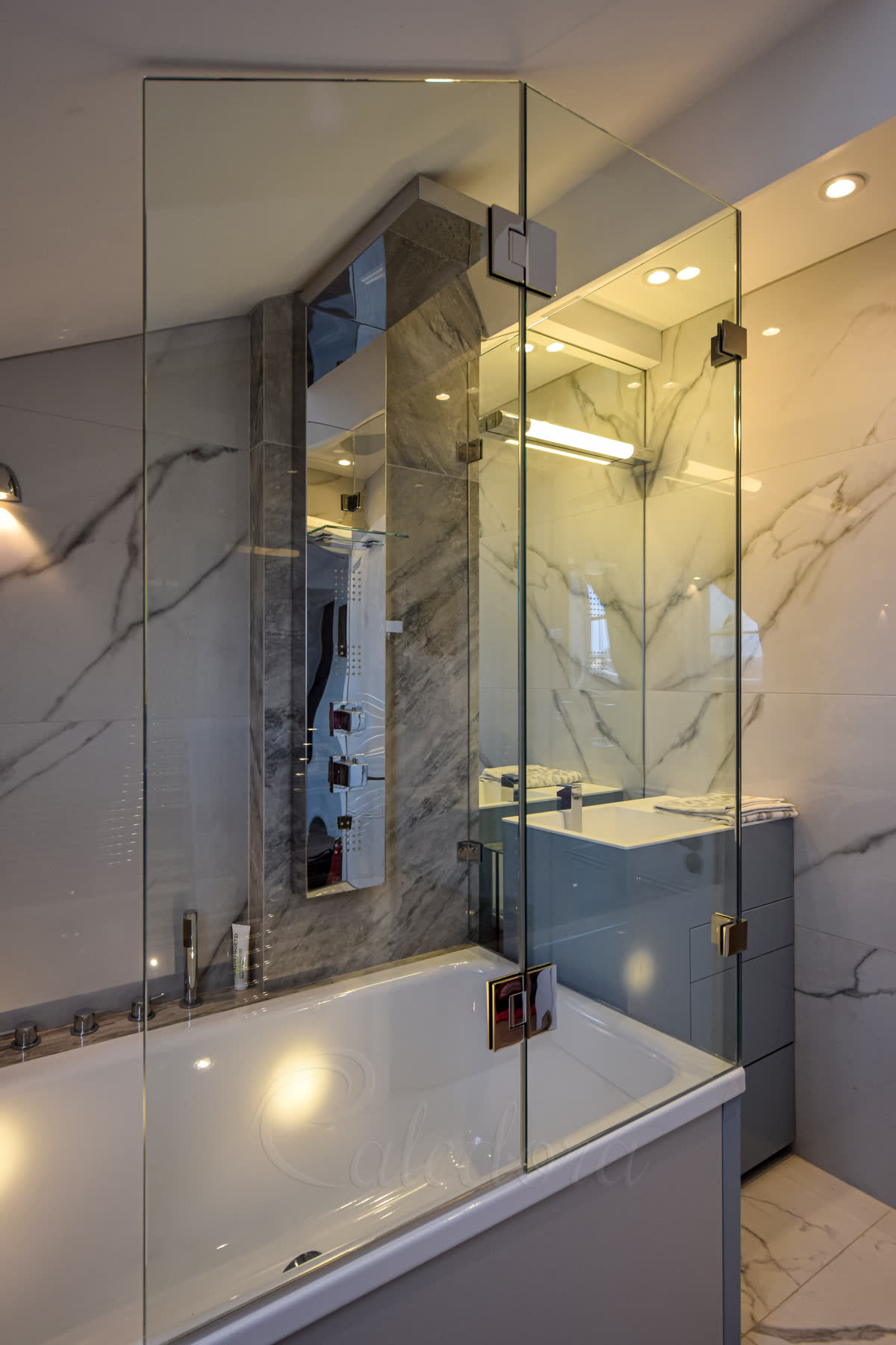 Full view of over bath shower enclosure with minimalist frameless design and clear glass panels