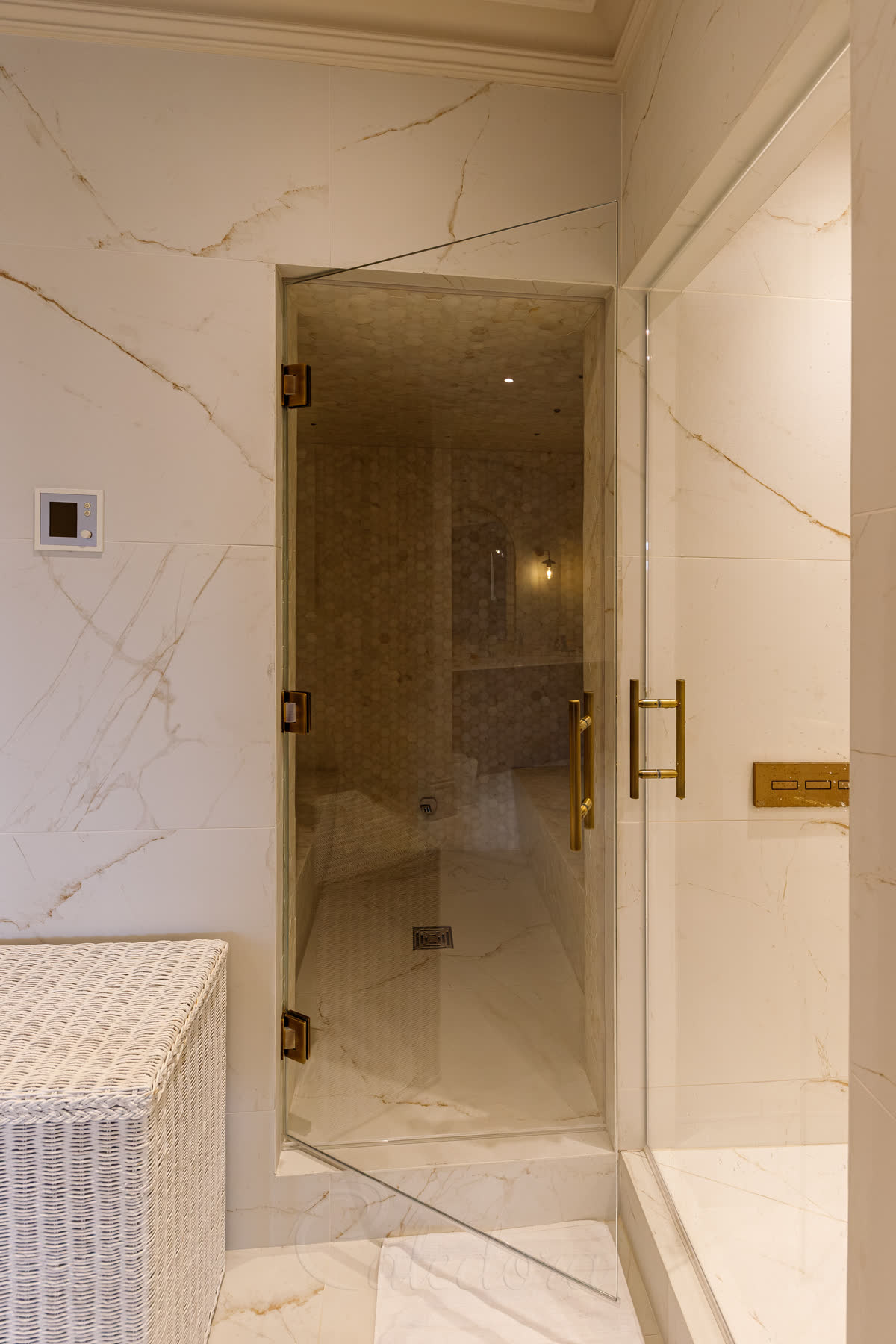 Steam room door opening to reveal tiled bench seating and soft lighting