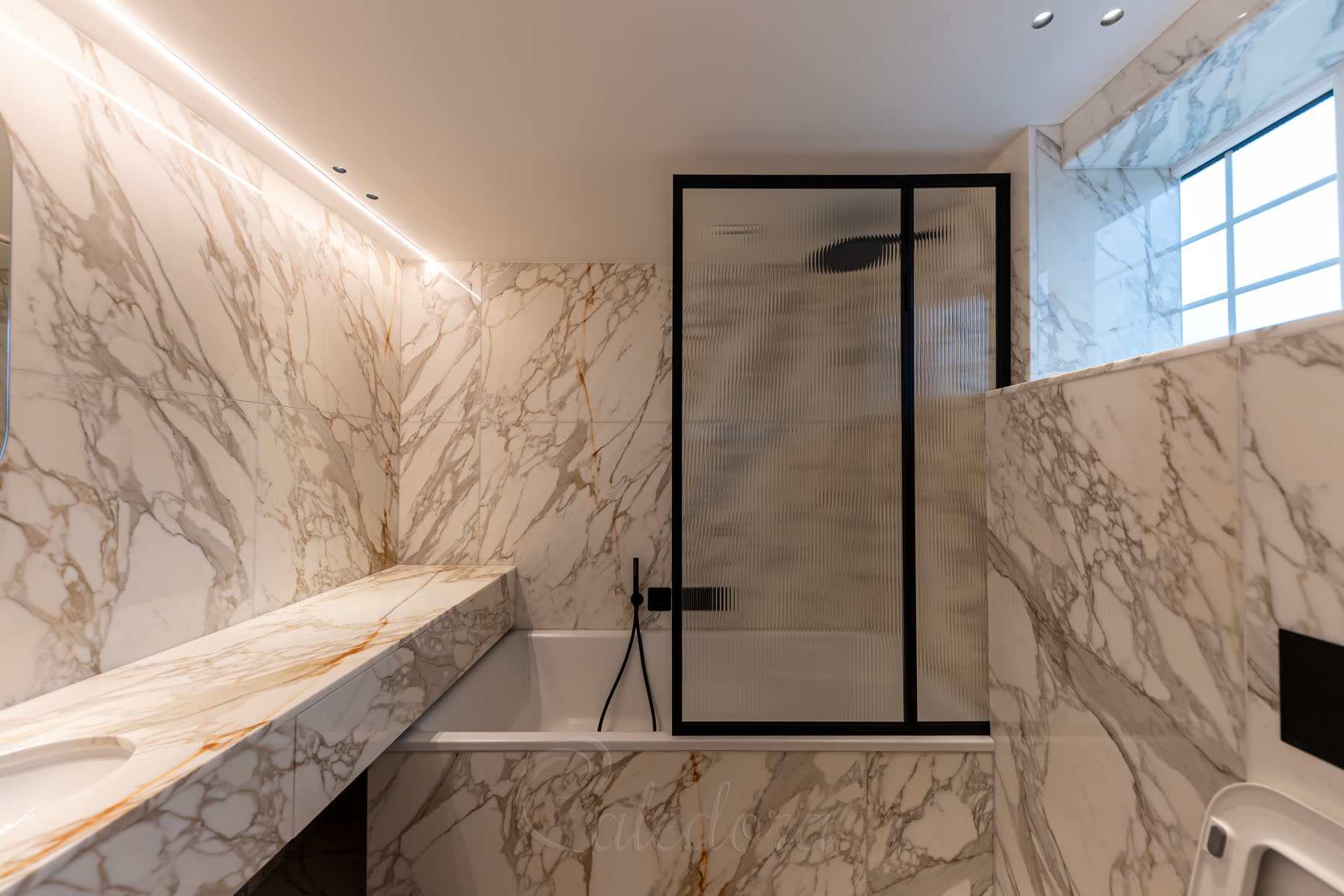 Open black folding bath screen showing the frame details and reeded glass pattern