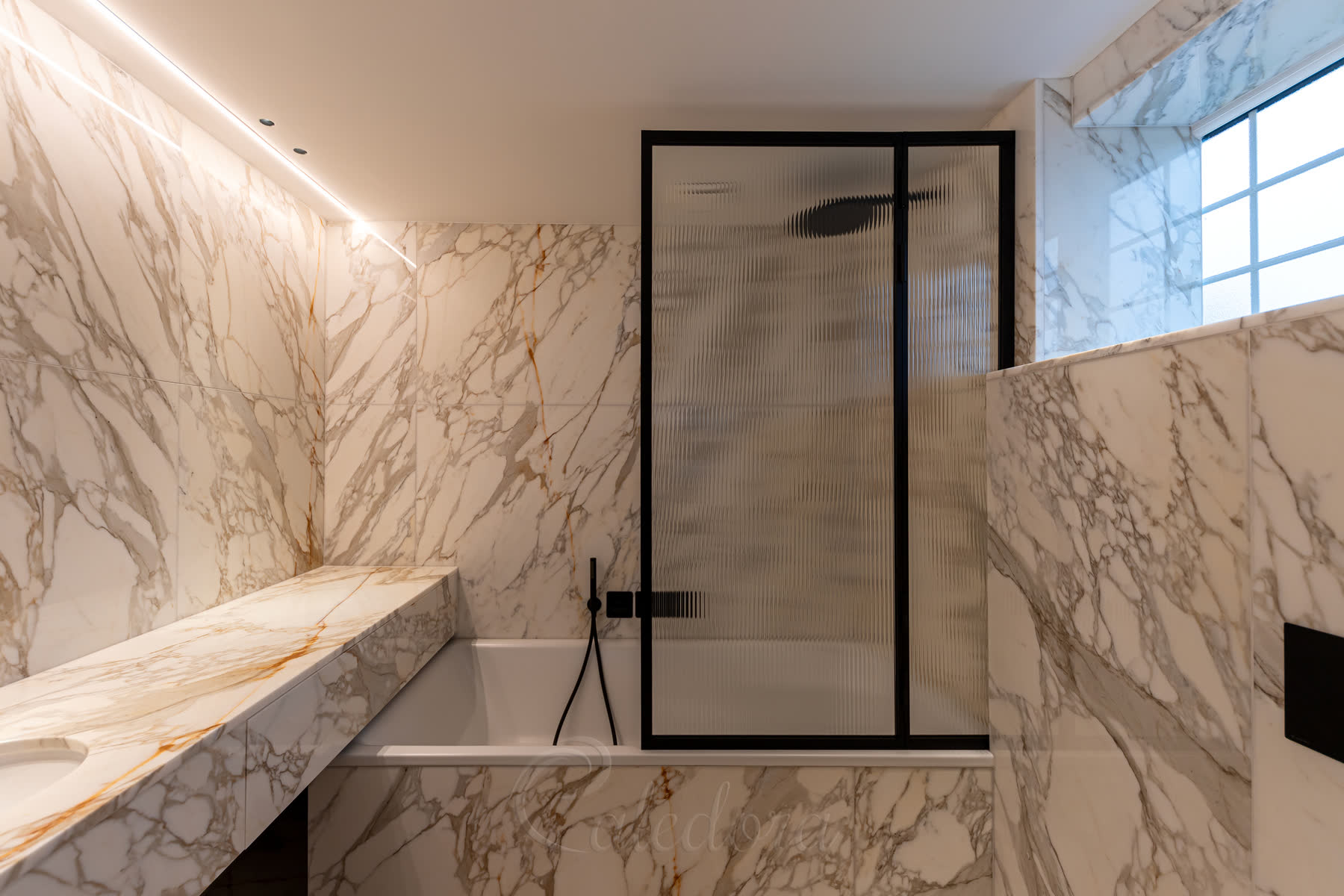 Black bath screen shown in open position displaying how the panel swings both inward and outward