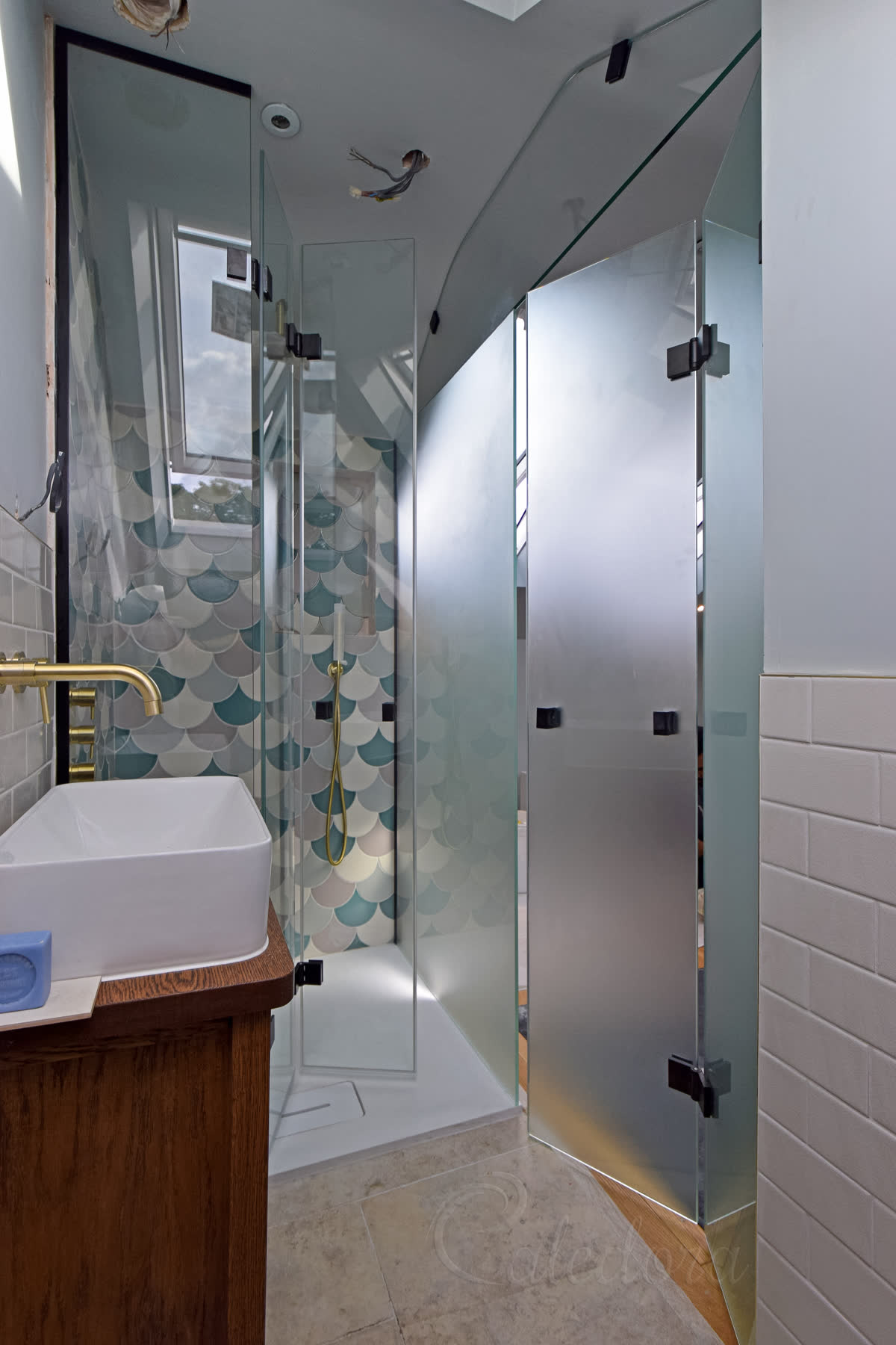 Black dual bifold system with both ensuite and shower doors partially open