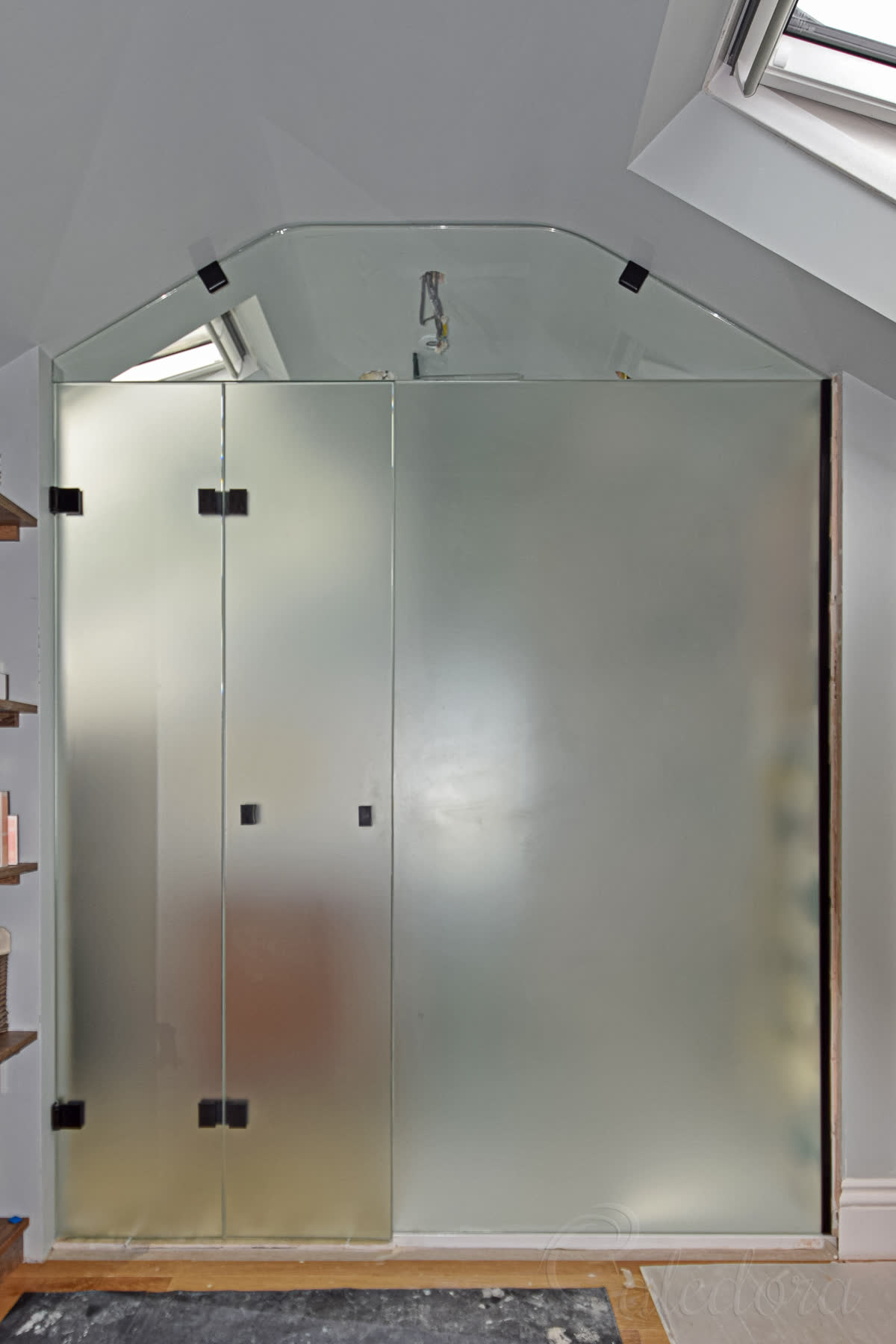 Black frosted glass partition closed providing complete privacy between bedroom and ensuite