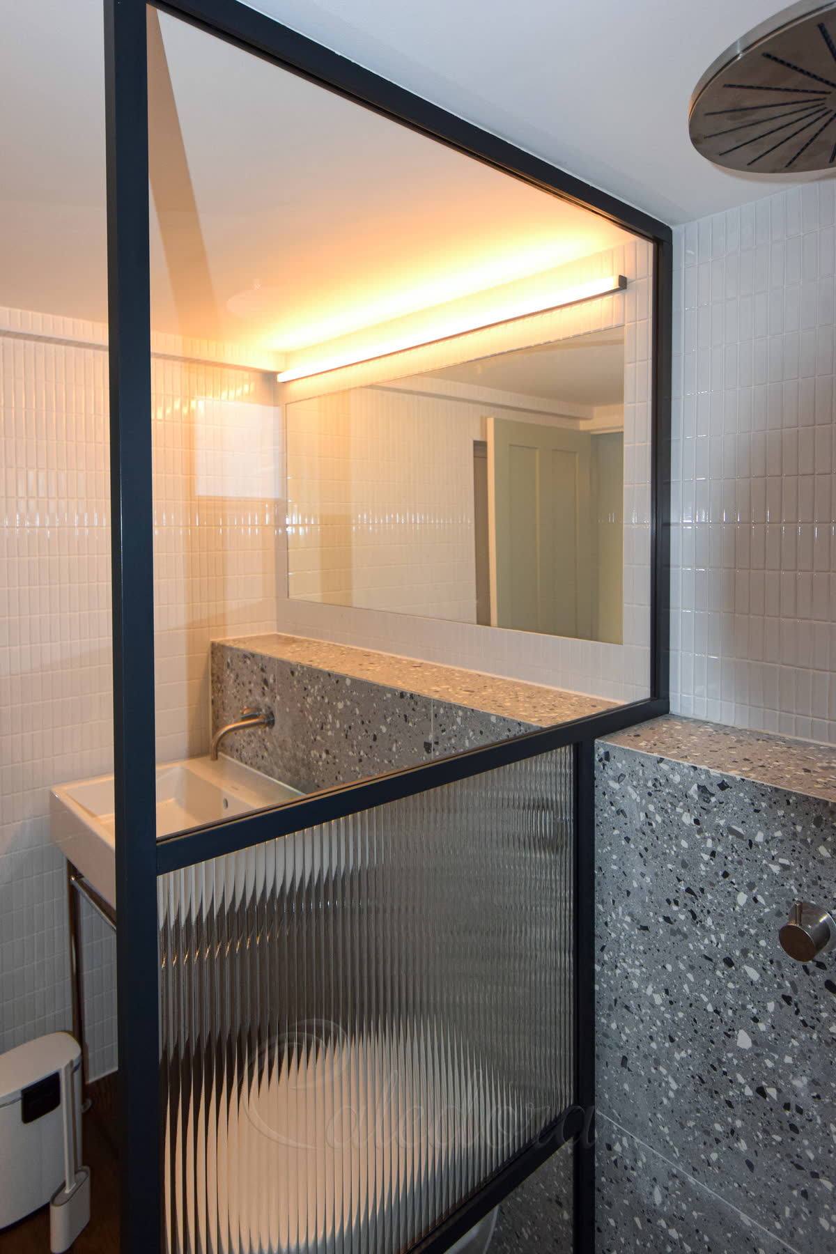 Shower screen with black frame featuring mixed laminated glass and custom notch for shelf