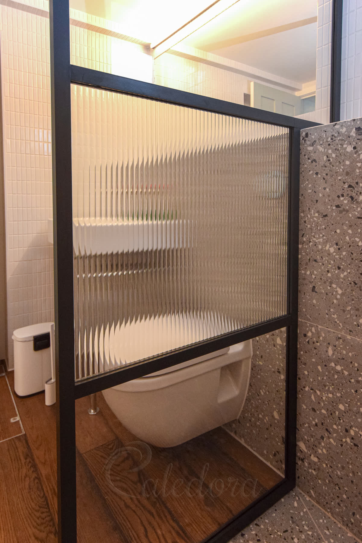 Close-up of black anodised frame with fluted glass texture creating privacy while maintaining light