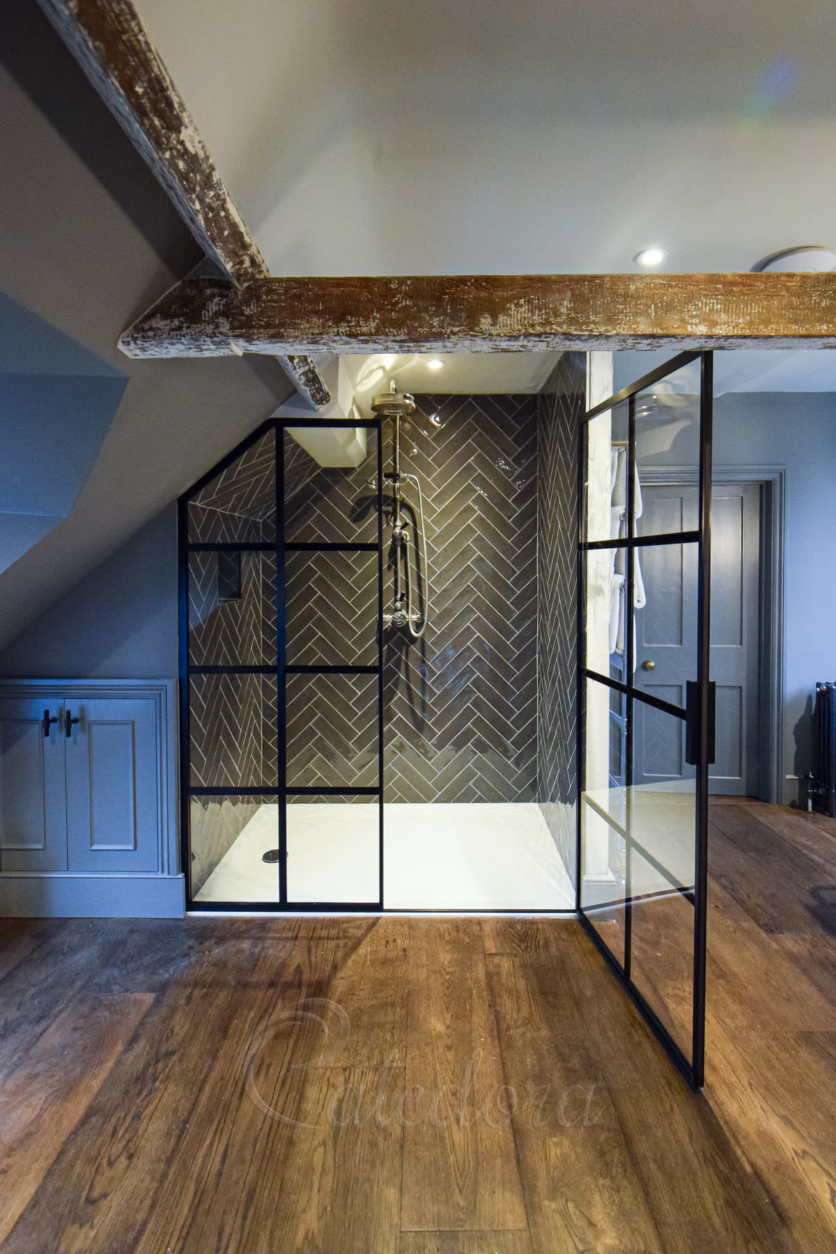Fully open black grid shower door showing clean interior with no interior grid bars for easy cleaning
