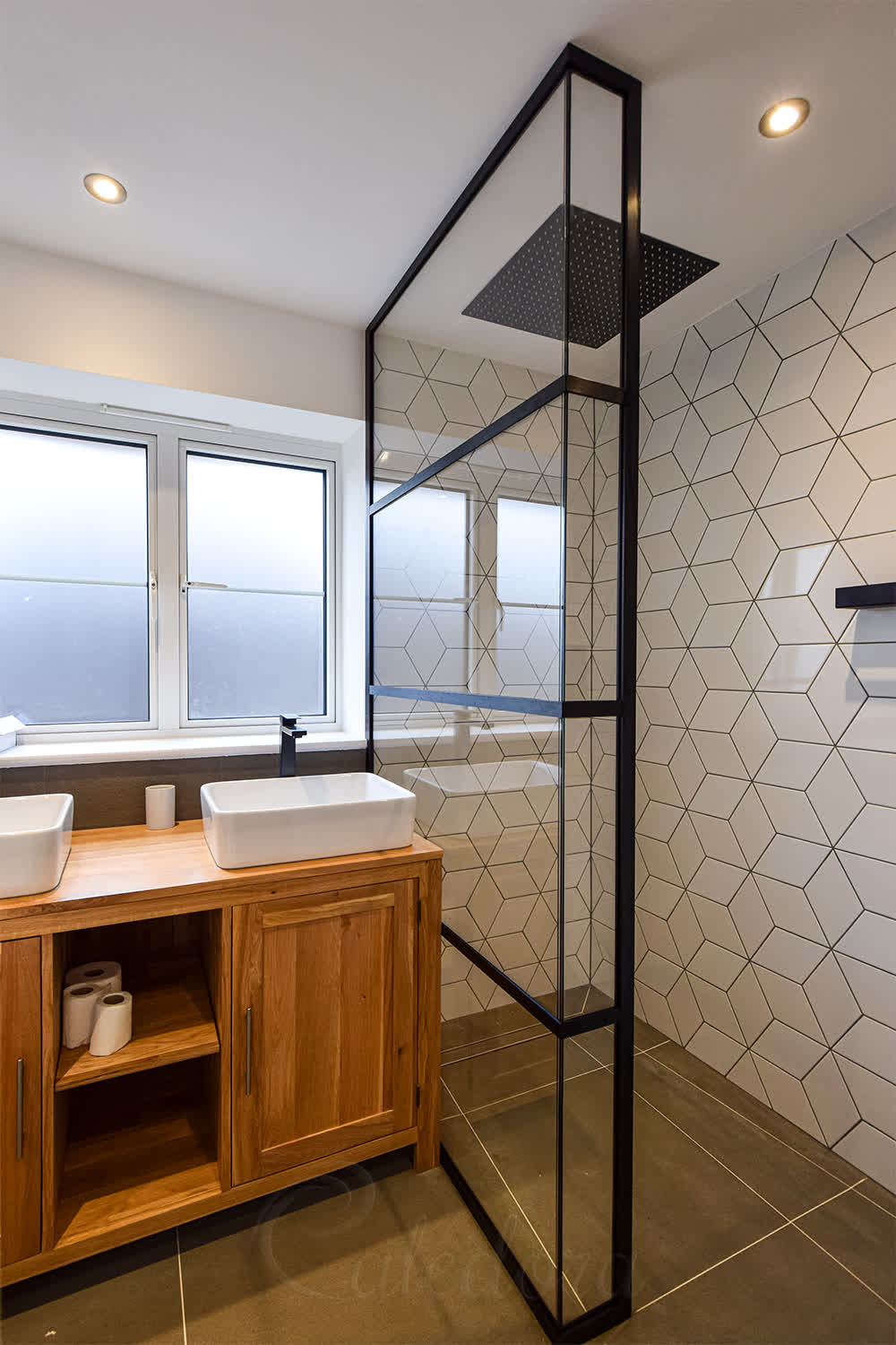 Black L-shaped shower screen with grid frame showing UV-bonded fixed panels