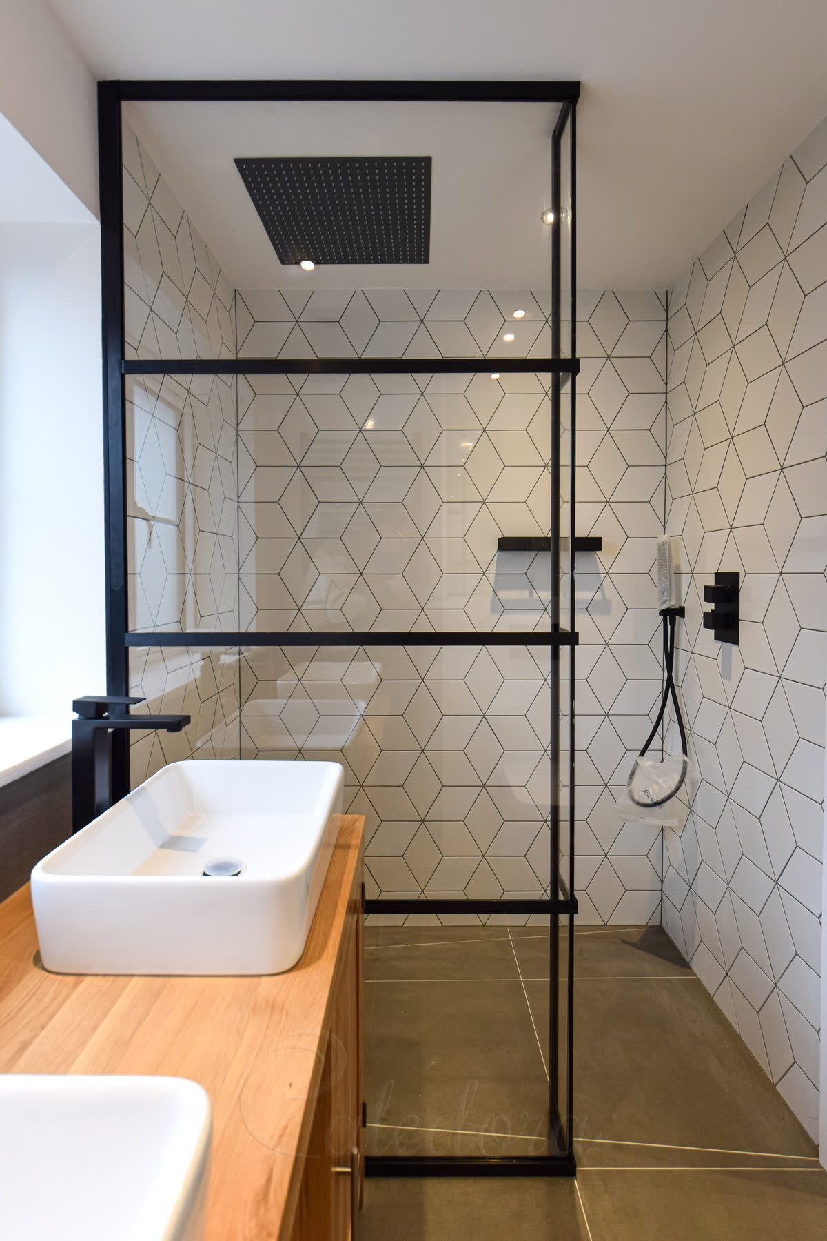 Full height black grid shower screen with clear glass panels and horizontal bars
