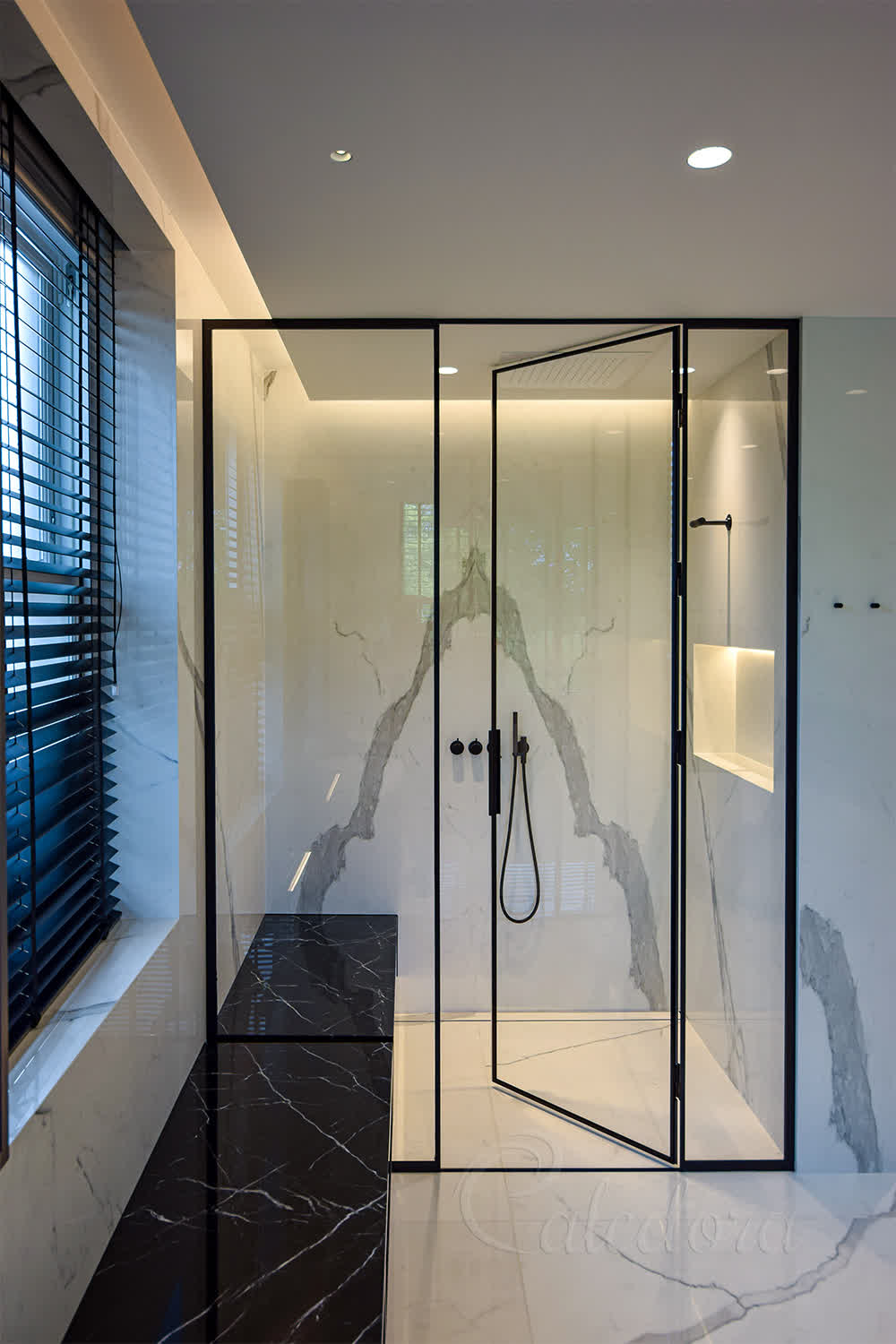 Black framed shower enclosure with ultra clear glass in luxury marble bathroom