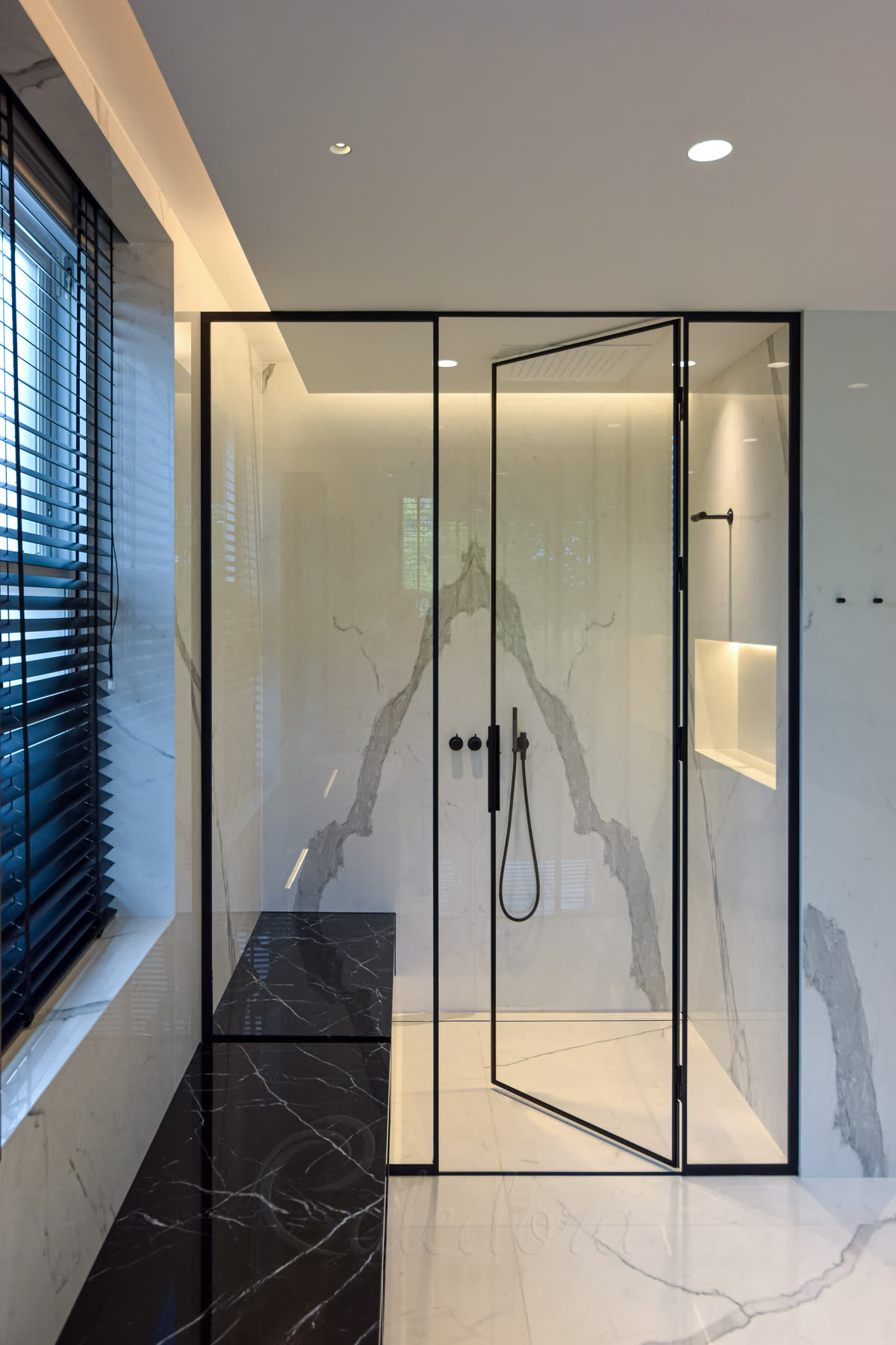 Black framed shower enclosure with ultra clear glass in luxury marble bathroom