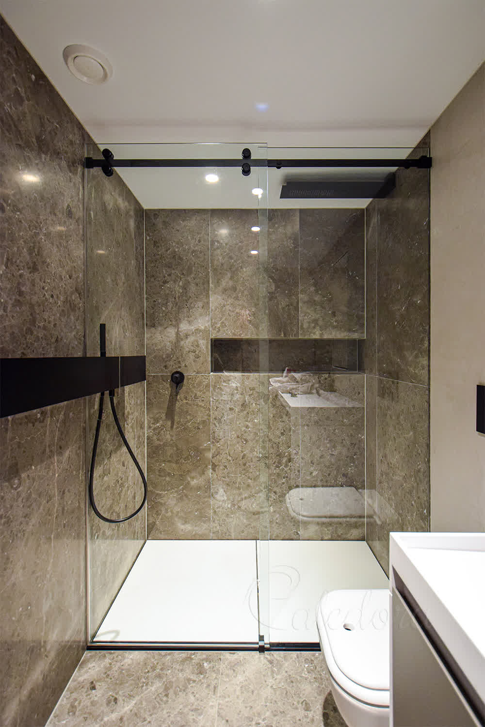 Black sliding shower door with custom cut-out for wall shelf