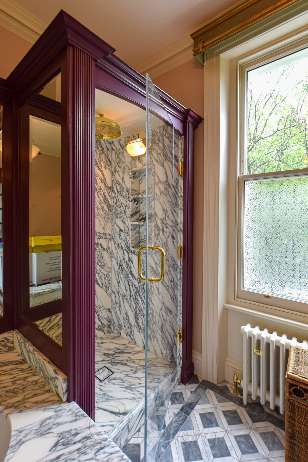 Brass shower door opened inward showing 850mm wide clear glass panel