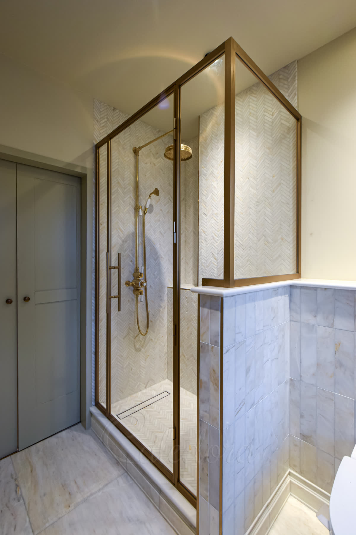Luxury brass shower enclosure with ladder-style glass handle and bespoke finish