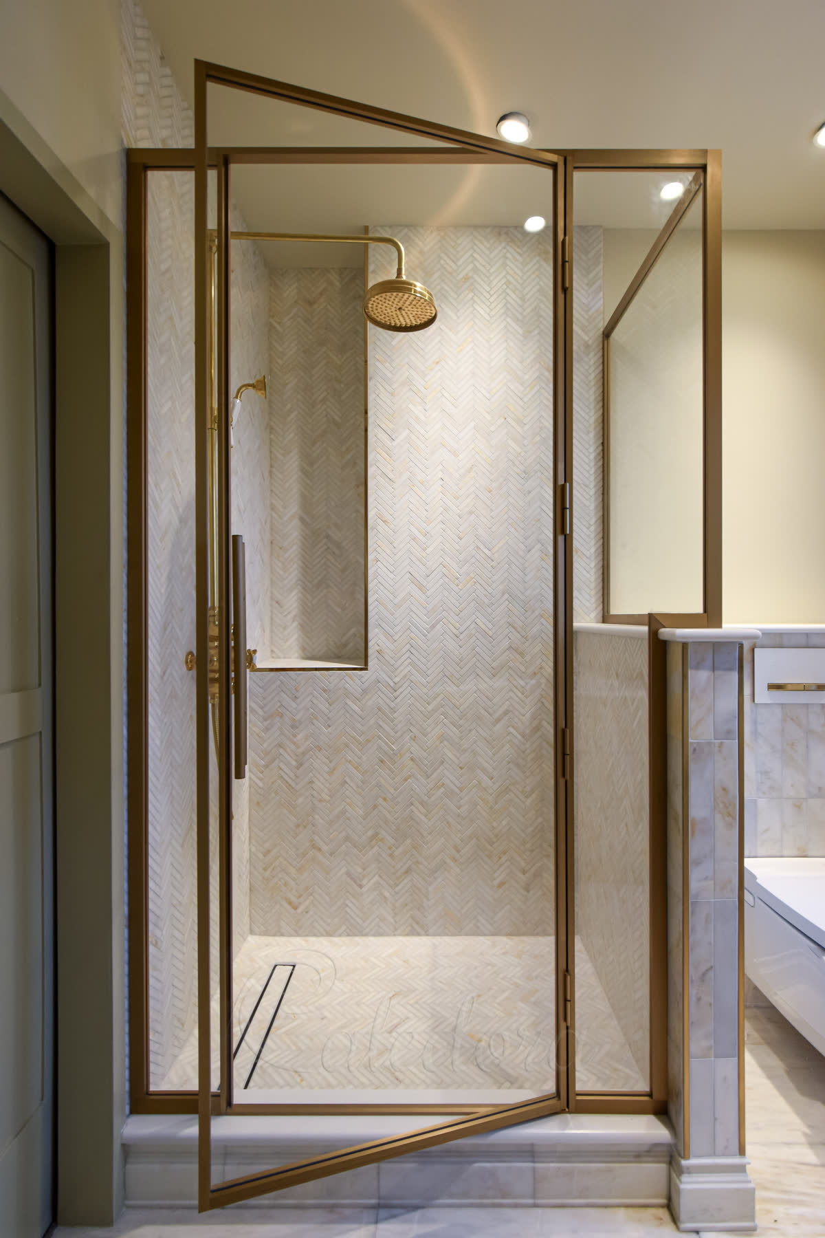 Custom brass shower door with ultra clear glass and brass frame details