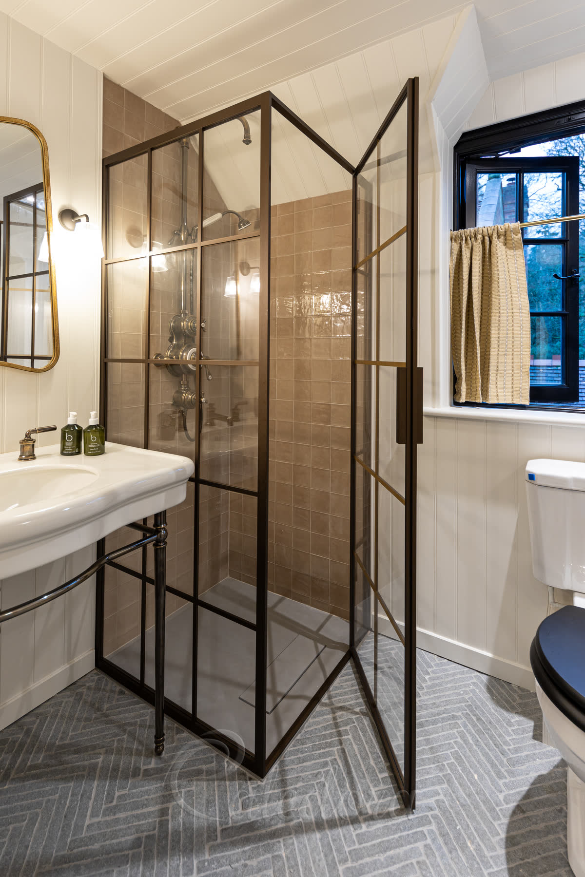 Close-up of bronze grid shower enclosure showing the detailed frame and ultra clear glass