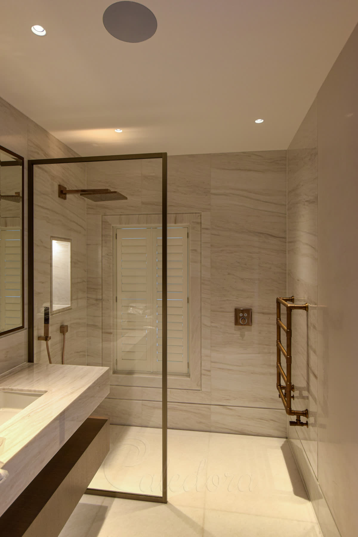 Walk-in shower screen with bronze framing and clear minimal seals