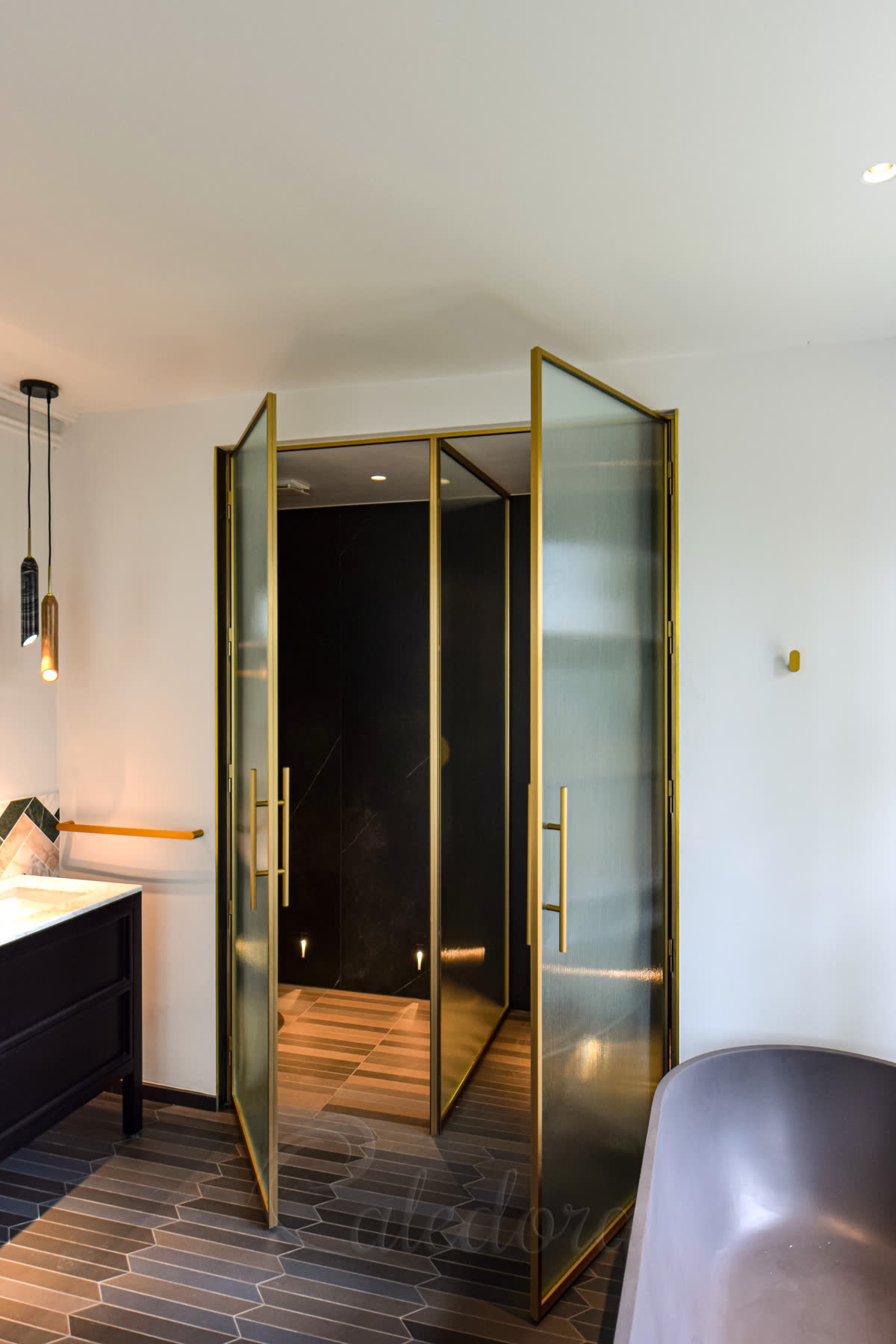 Both brass doors open showing the fixed partition screen between shower and WC areas