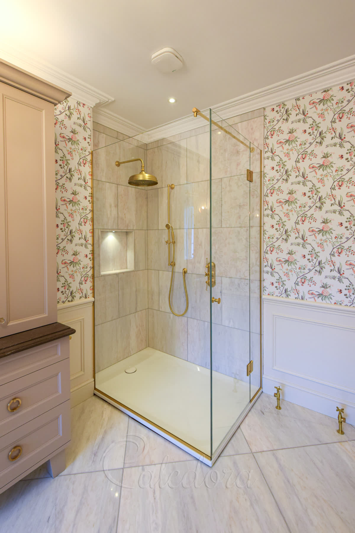 Frameless brushed brass corner shower enclosure with Ultra Clear glass and swing door