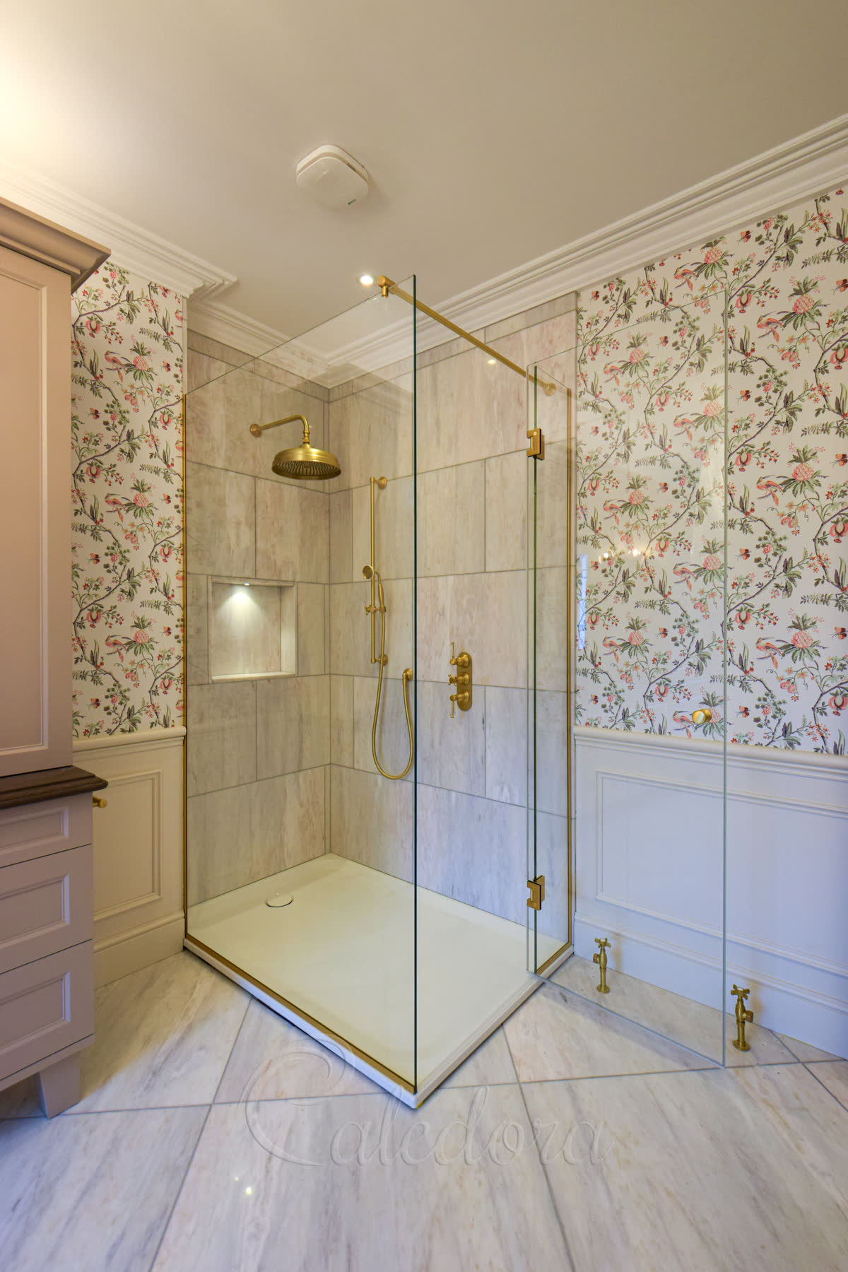 Ultra Clear frameless brass shower enclosure showing air extractor gap above glass