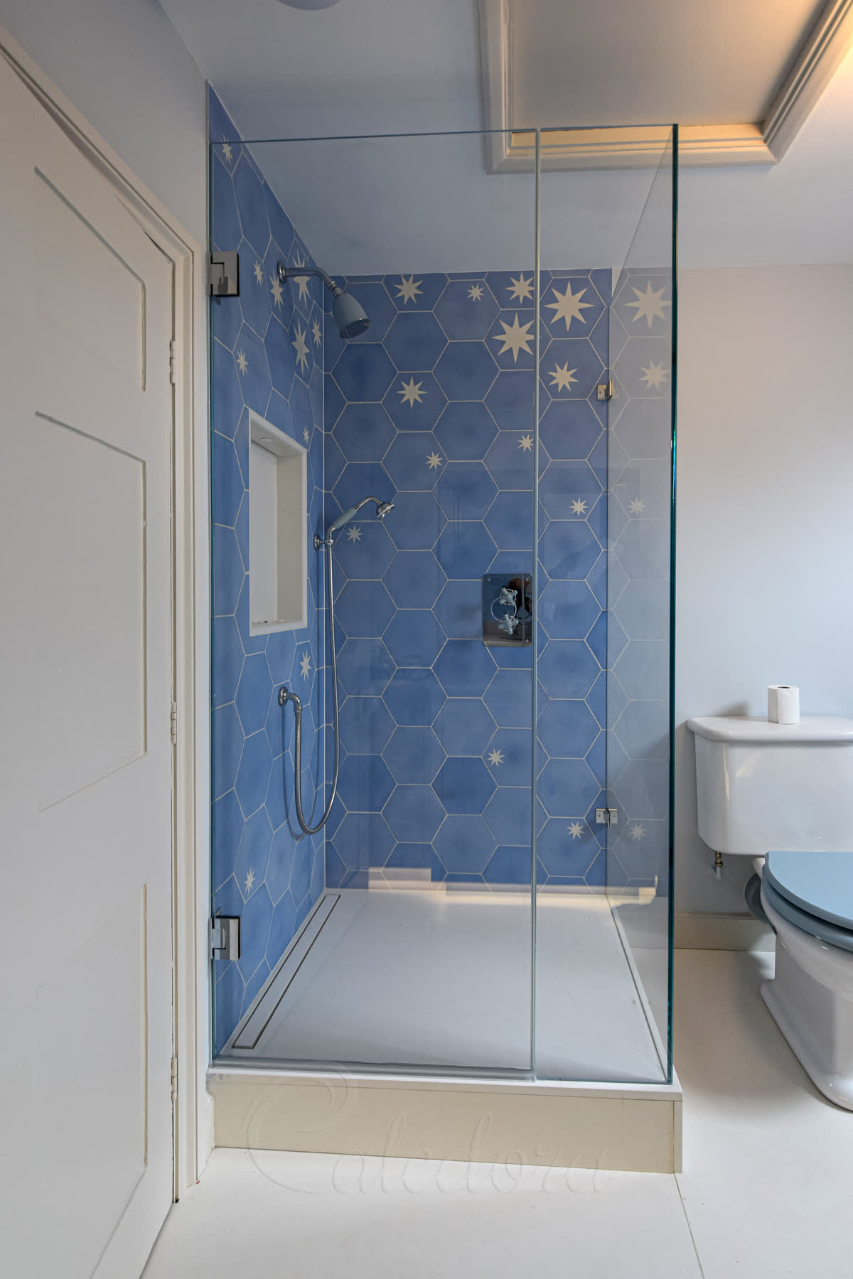 Chrome shower enclosure installation with wall brackets and frameless design in Bristol bathroom