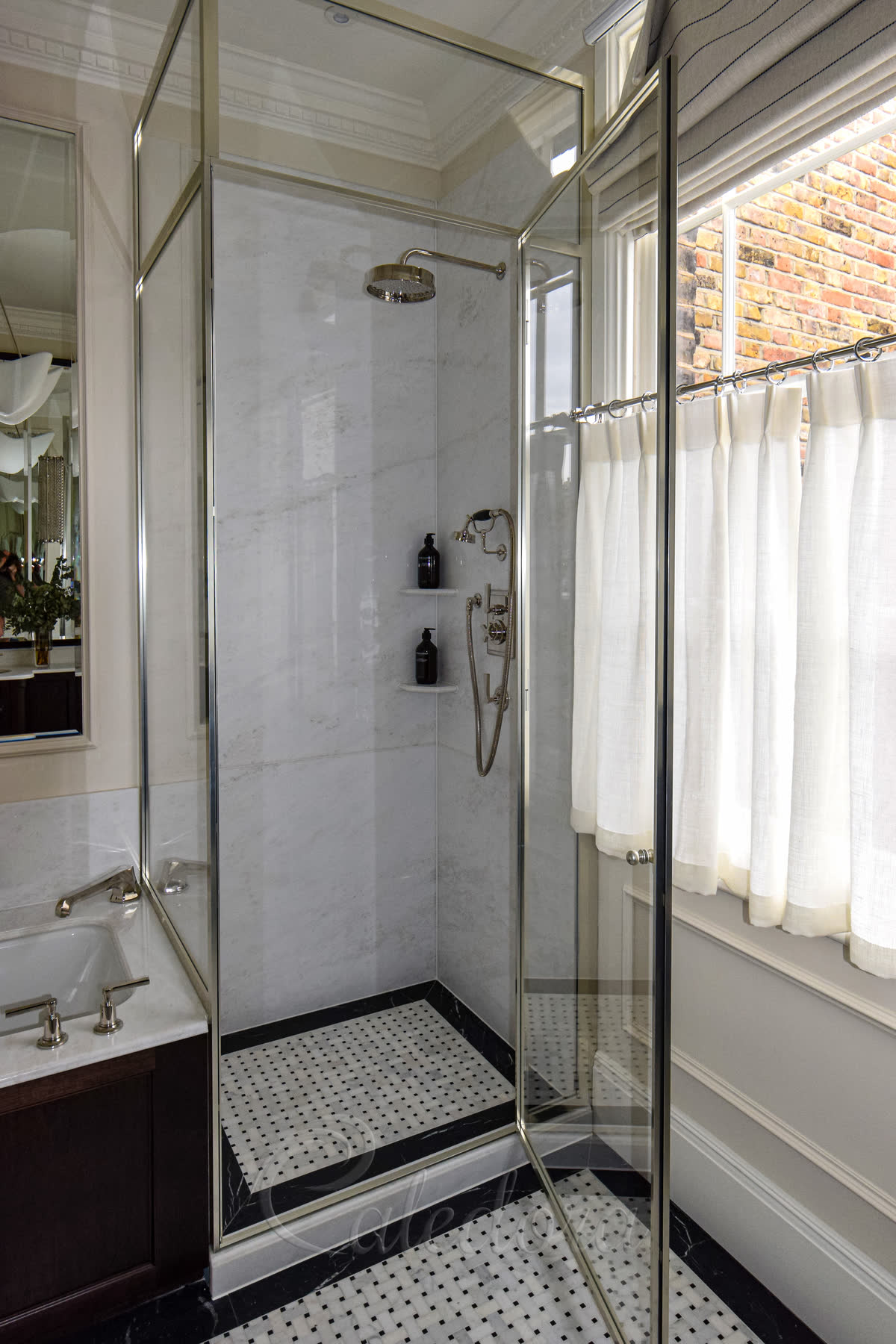 Framed nickel corner shower enclosure with Ultra Clear glass installed over bath edge