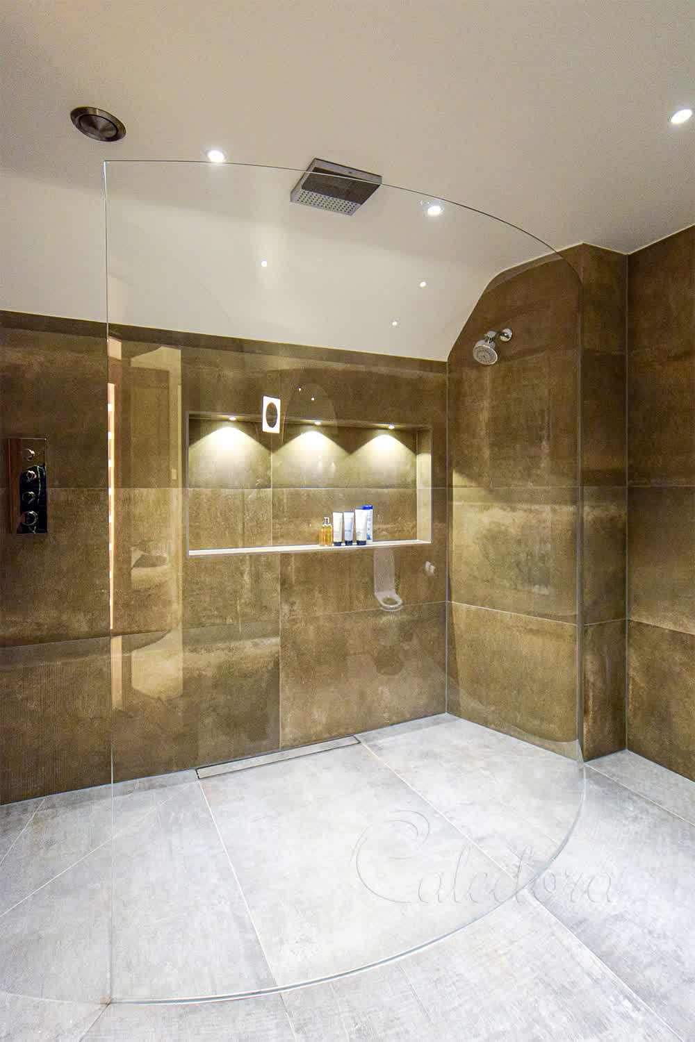Frameless curved shower screen with perfect radius in luxury Sussex bathroom