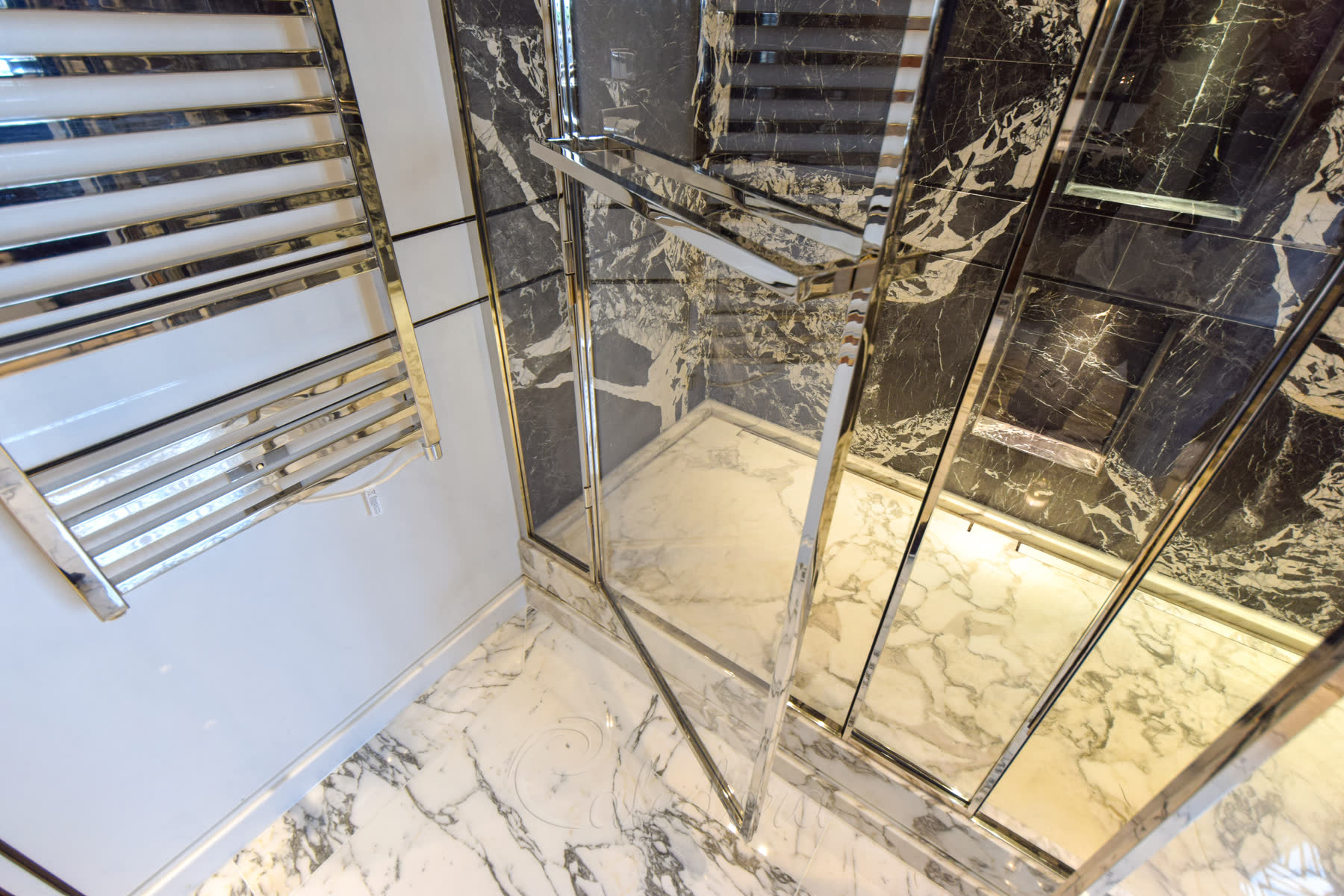 Close-up of seamless joints on luxury double shower enclosure with nickel finish