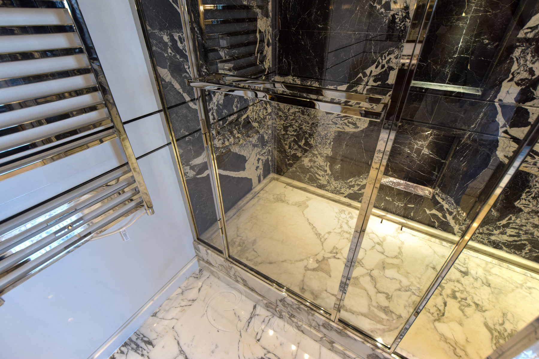 Interior view of double shower with two separate shower areas and frameless design