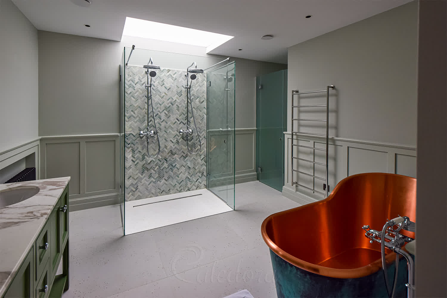 Double shower enclosure with two swing doors, dual shower heads, and skylight above in bathroom with copper bath