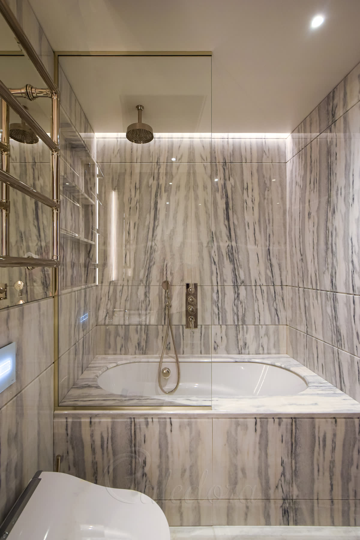 Full height fixed bath shower panel with polished nickel U-channels installed over half of the bath