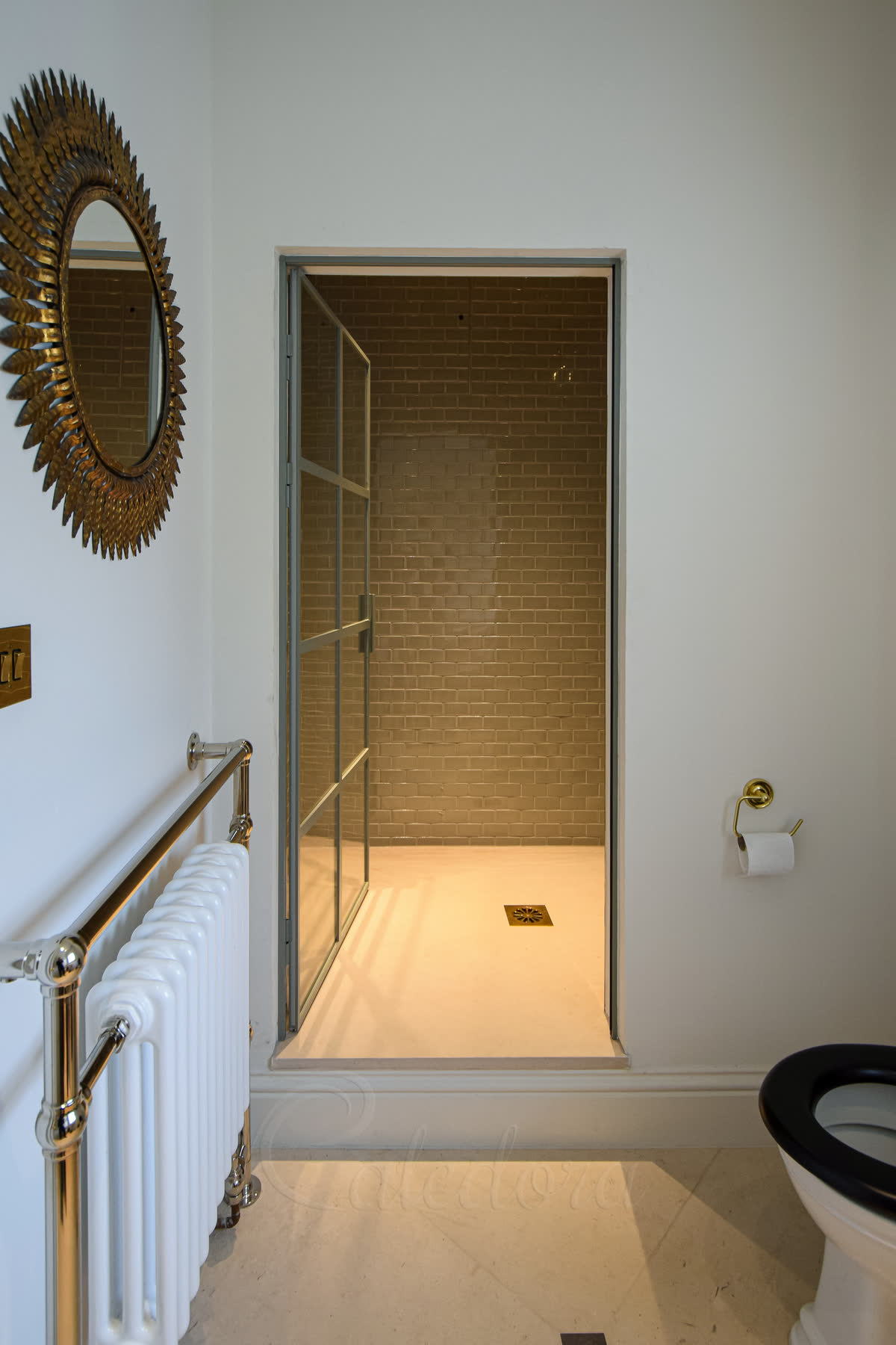 Light grey framed shower door with grid pattern shown fully open with visible metal grid in West Sussex bathroom