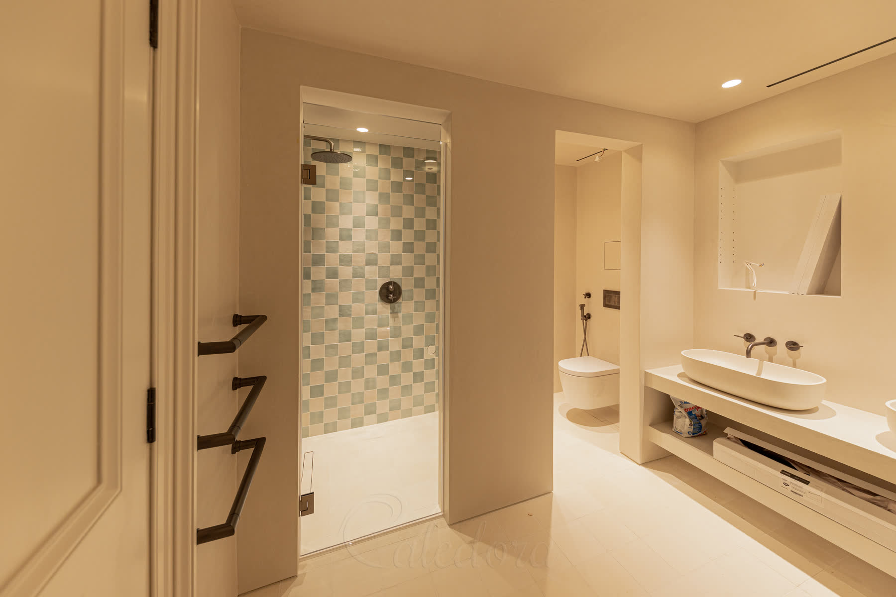 Hinged frameless shower door showing 150mm ventilation gap above for steam release