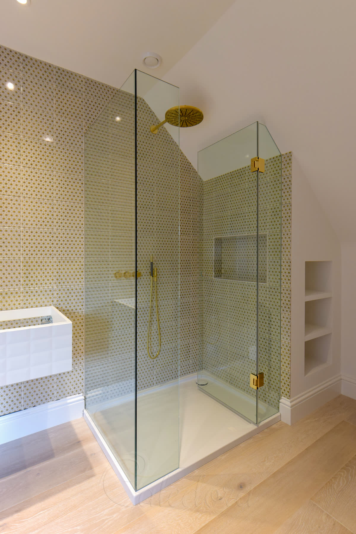 Frameless shower enclosure under sloped loft ceiling with recessed screens