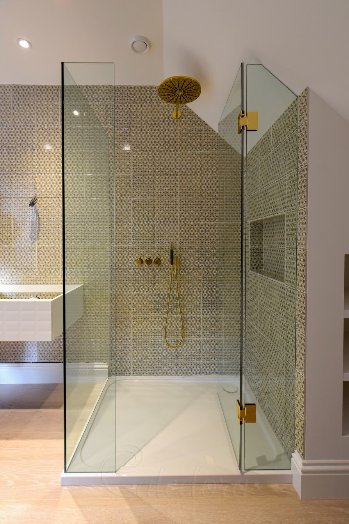 UV-bonded glass panels in corner loft shower with no metal bar