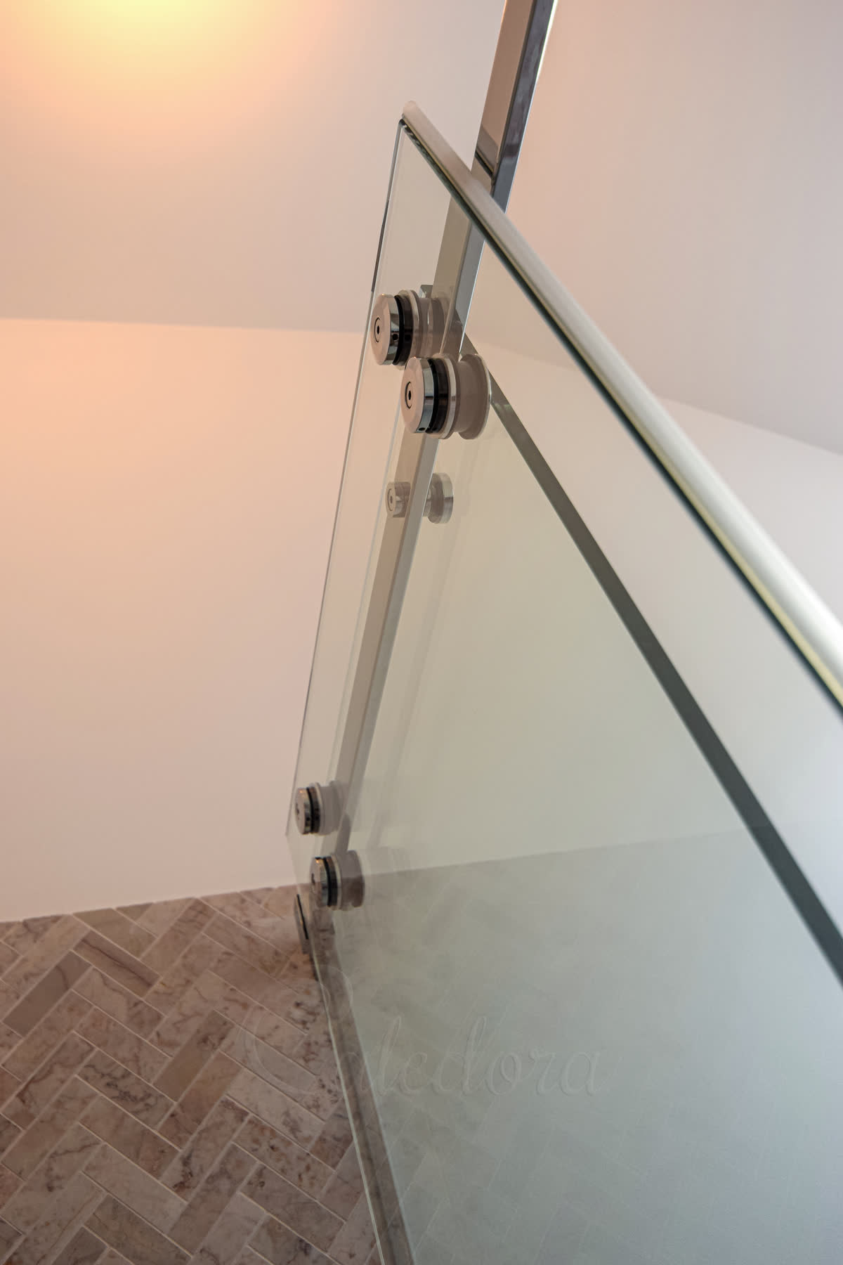 Interior view showing door rollers and minimalistic seals attached to glass panel for smooth sliding operation