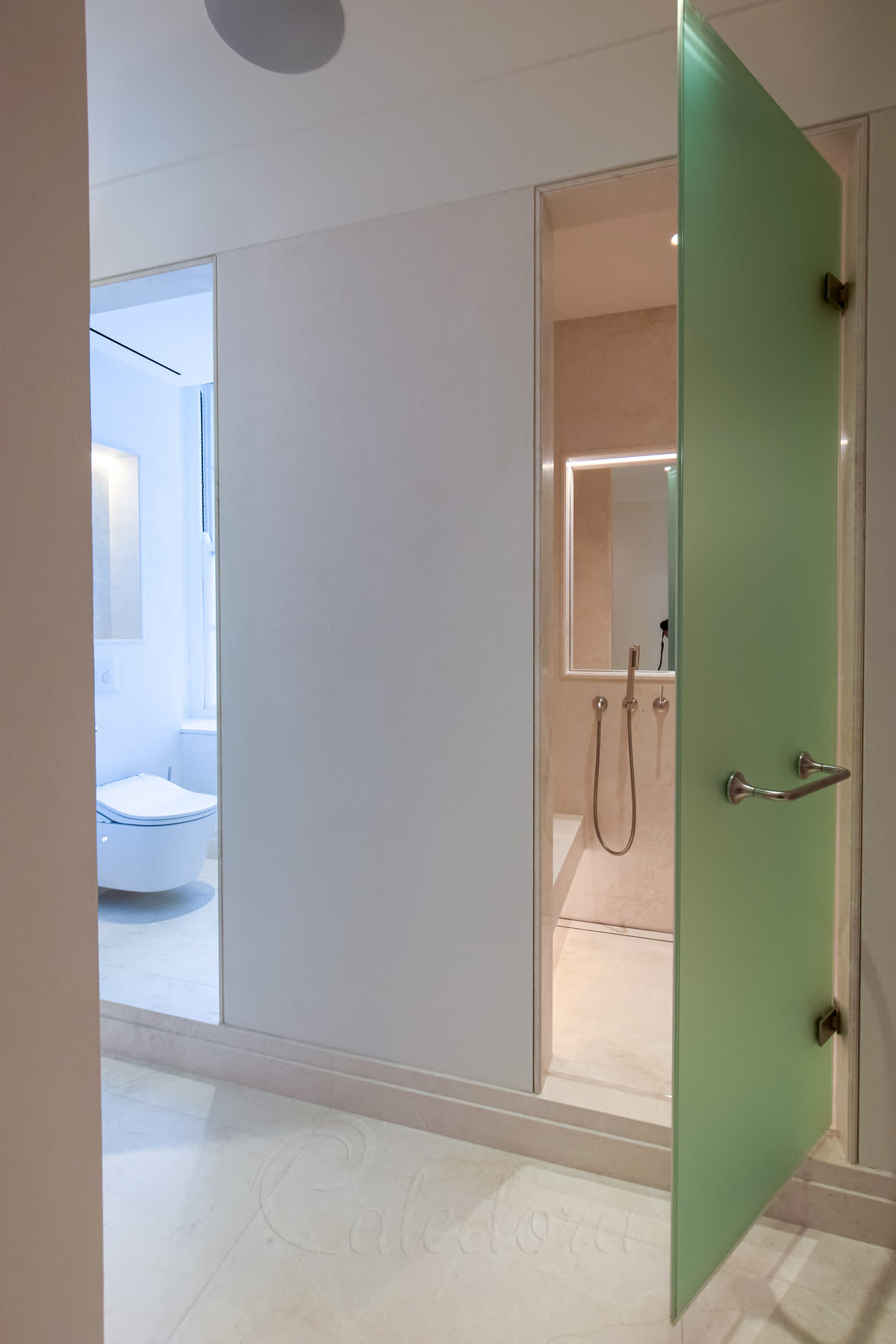 Close-up of frosted glass shower door showing ventilation gap and minimal sealing for clean aesthetics