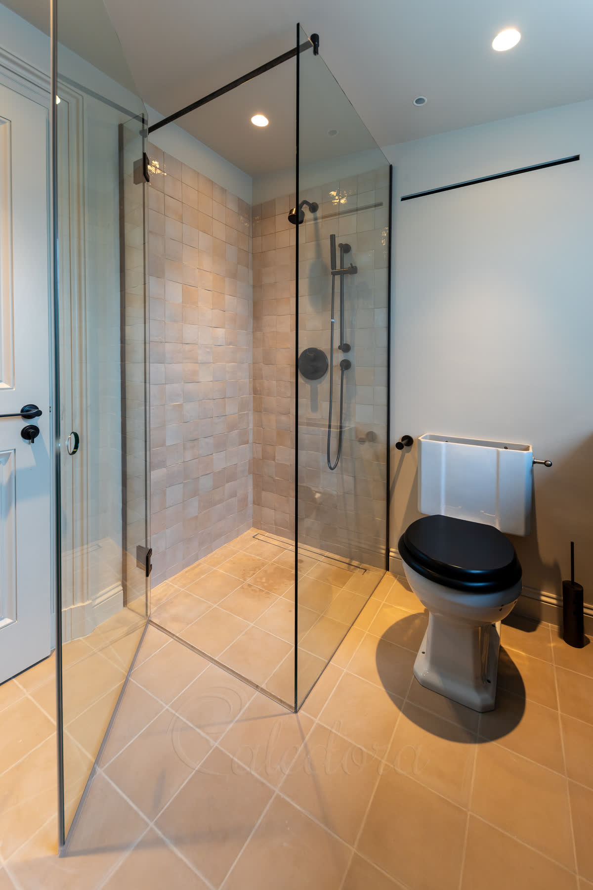 Gunmetal shower enclosure door slightly open showing bathroom door clearance design