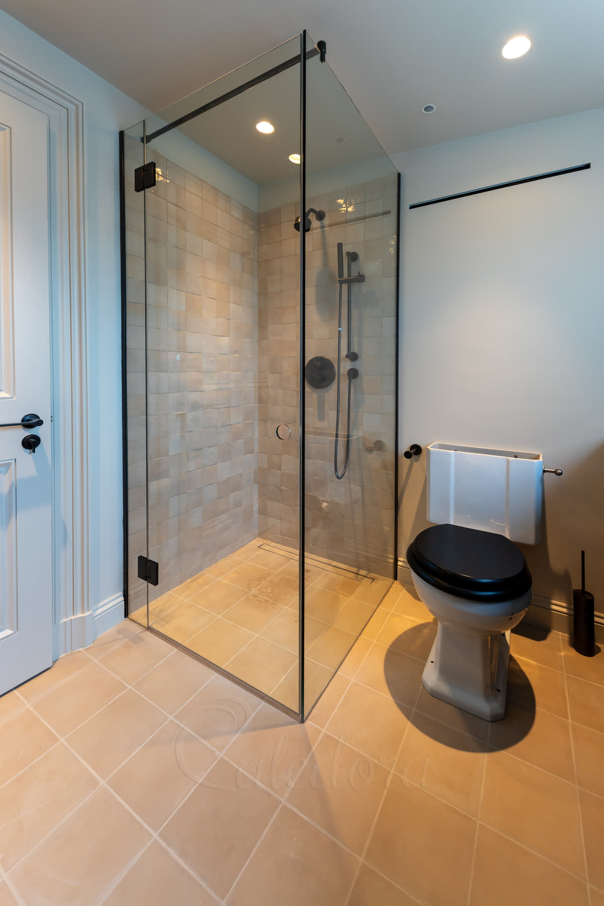 Gunmetal shower enclosure with frameless design and PVD coated hardware